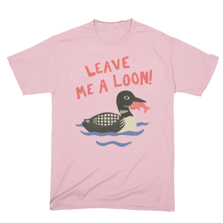 Pink T-shirt with a cartoon loon holding a fish in its beak and the text 'LEAVE ME A LOON!' above it.