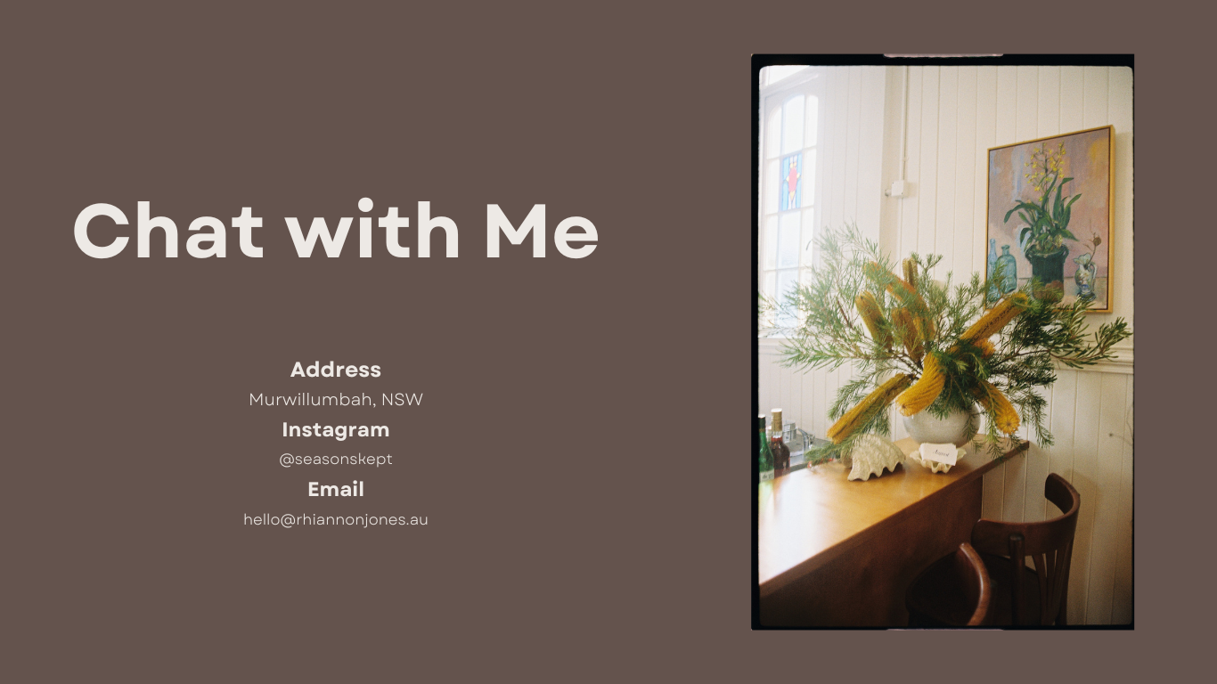 Business card with the text "Chat with Me" on the left and a photo of a floral arrangement on the right. The arrangement includes green foliage and yellow flowers in a white vase, placed on a wooden table near a window in a room with white paneling and artwork on the wall.
