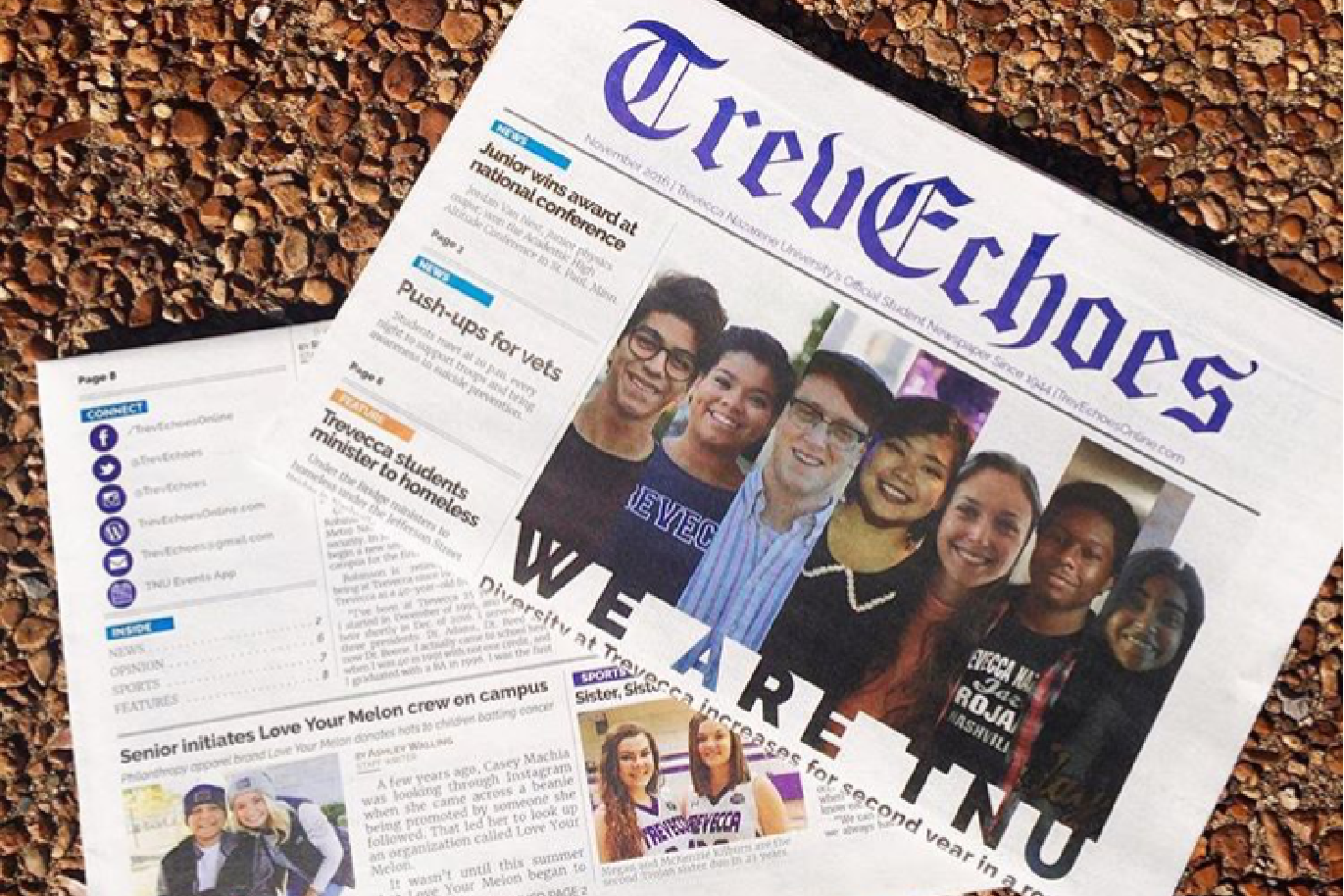 A newspaper titled "Truechas" with photos of diverse students on the front page, placed on a gravel surface.