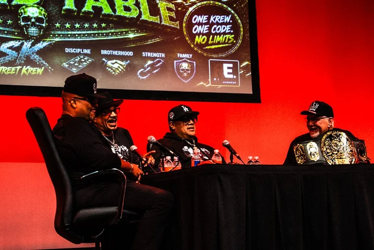 Rikishi sharing a laugh at the panel table