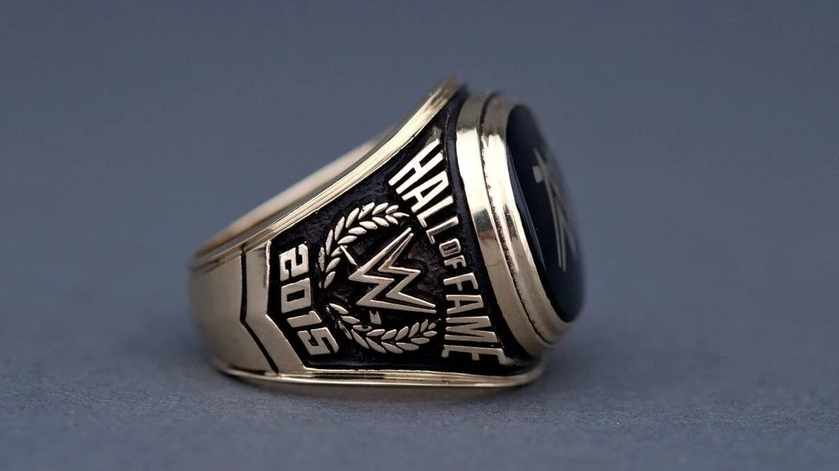 Close-up of a silver championship ring with black accents, engraved with 'Hall of Fame 2015' and a lightning bolt symbol.