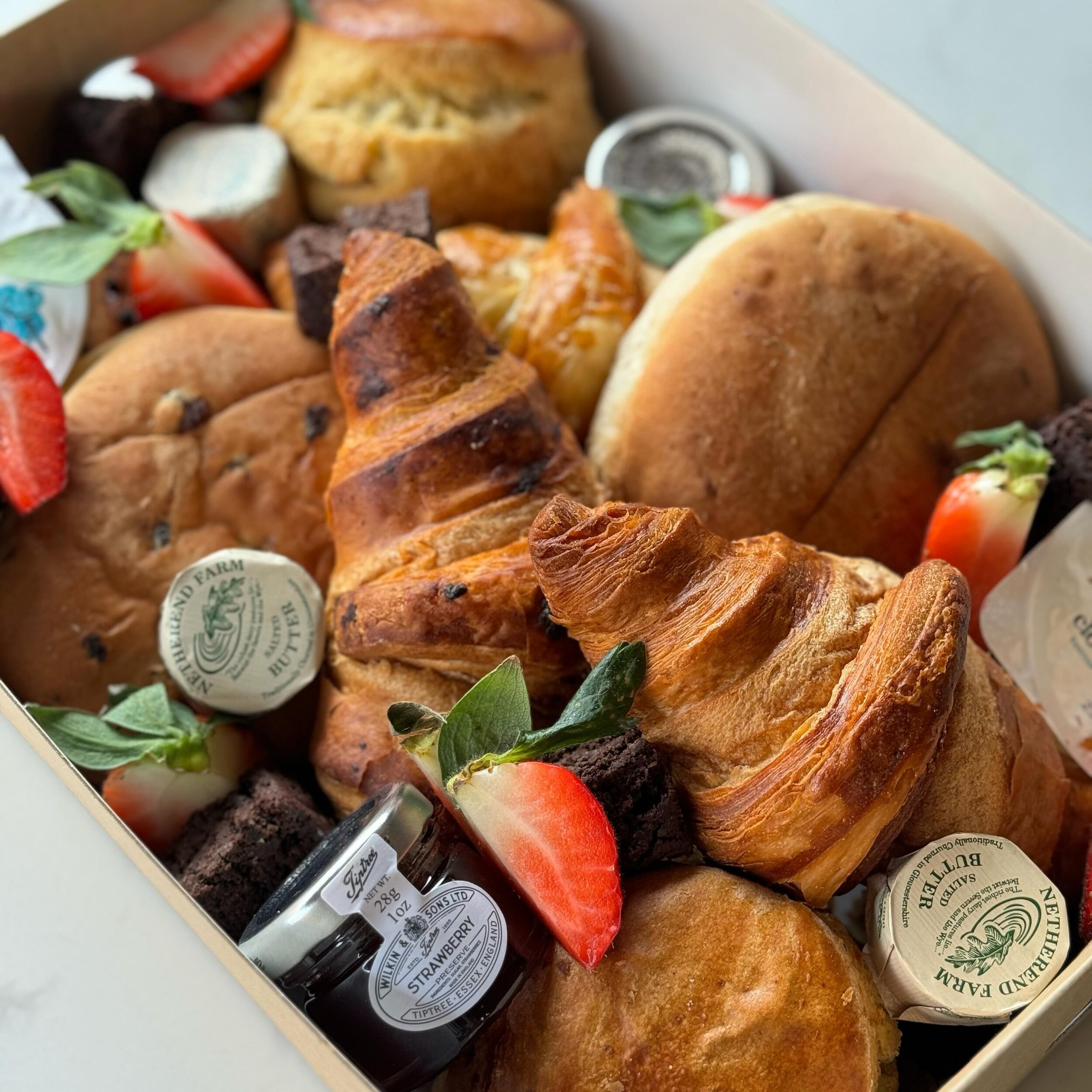 Introducing our Mother&rsquo;s Day breakfast box! ⁣
Available to order from our Warley Deli this Mother&rsquo;s Day 📍🌷⁣
⁣
Breakfast in bed? We&rsquo;ve got you covered 🥐 🍓 Packed with freshly baked croissants, tea cakes and Tiptree jam. Homemade 