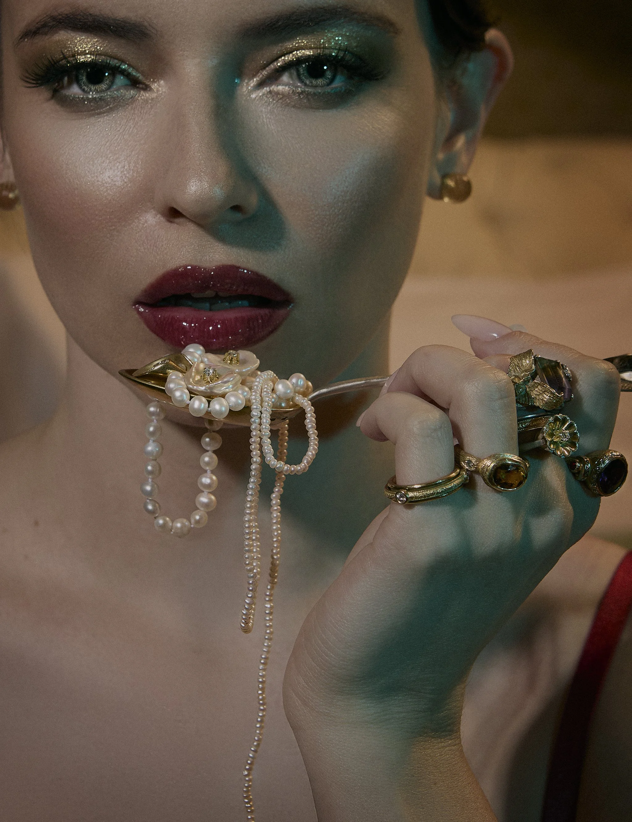 Luxury boudoir photography of a woman in red lingerie lingerie with silver spoon and precious jewlery, captured by Amanda Gril, Ljubljana-based boudoir photographer specializing in elegant, cinematic portraits.