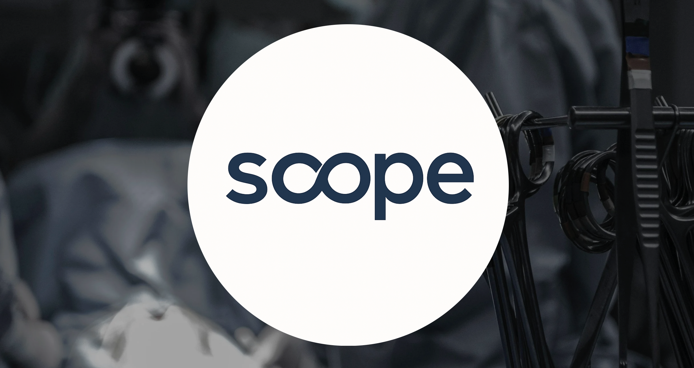 A black bicycle rack with multiple bike locks and a shopping cart in the background. Overlaid with the white circular logo of 'scope' in dark blue letters.