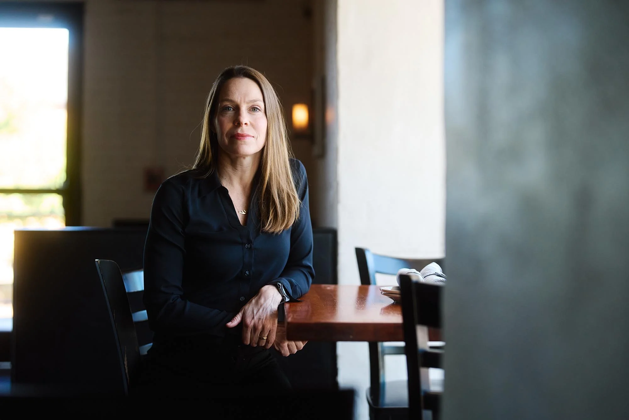 Kate Sheahan poses for a portrait in Venable Bistro, the restaurant where she works after being fired from the Federal government in Trump's sweeping layoffs. (for INDY Week).