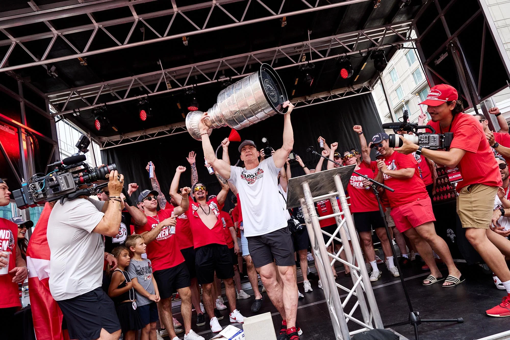 Coach Rod Brind'Amour lifts the Stanley Cup at a victory party in downtown Raleigh, NC. (for WUNC / NPR)