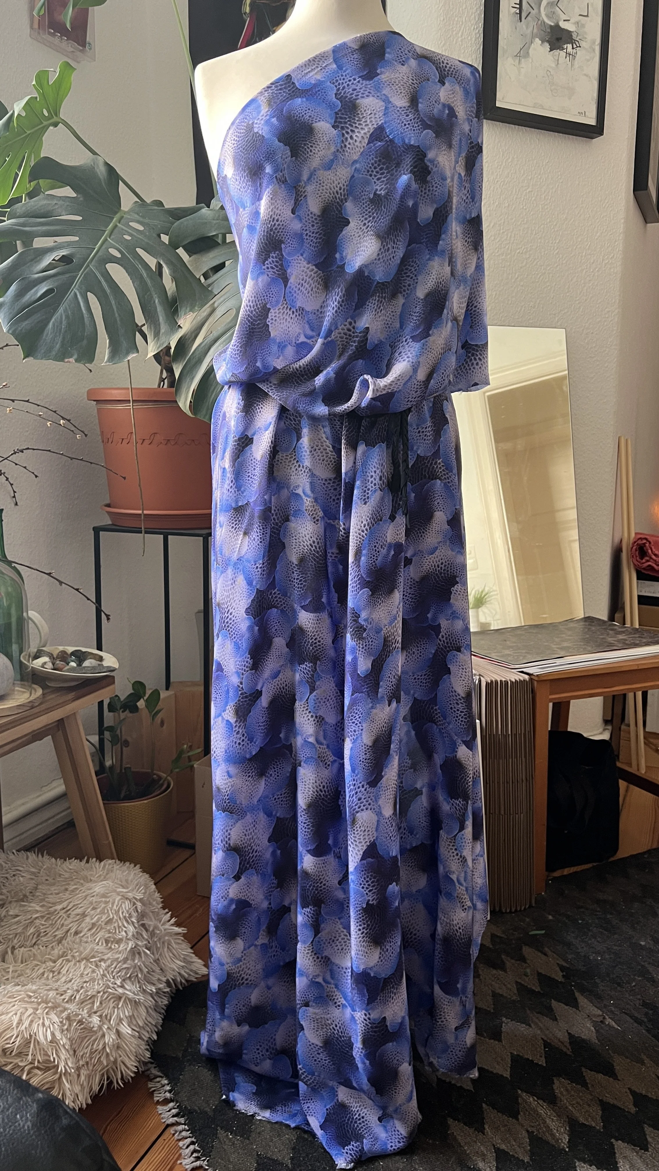 A mannequin draped in a purply-blue mushroom patterned print by Shhhroooms, printed on a silk viscose blend.
