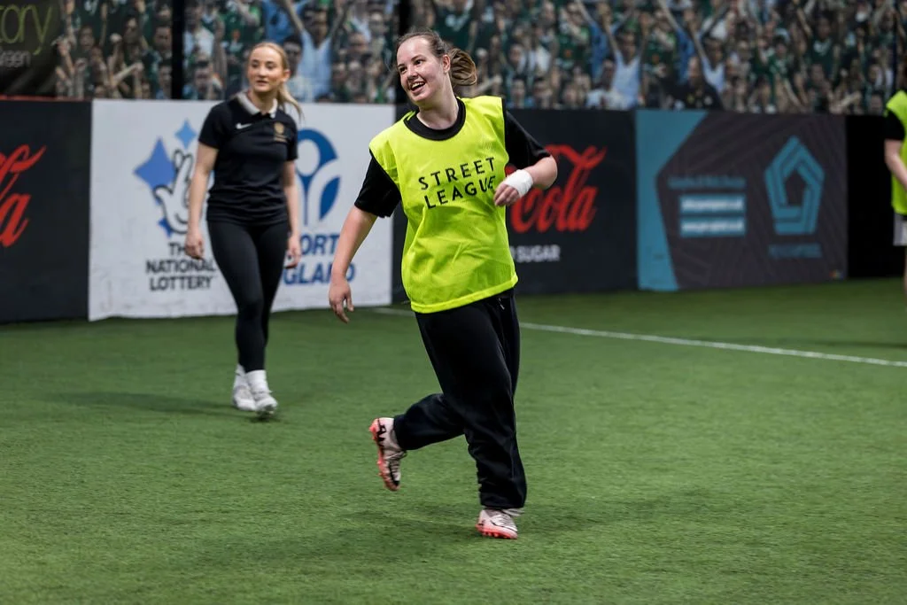 girl laughing on indoor football pitch