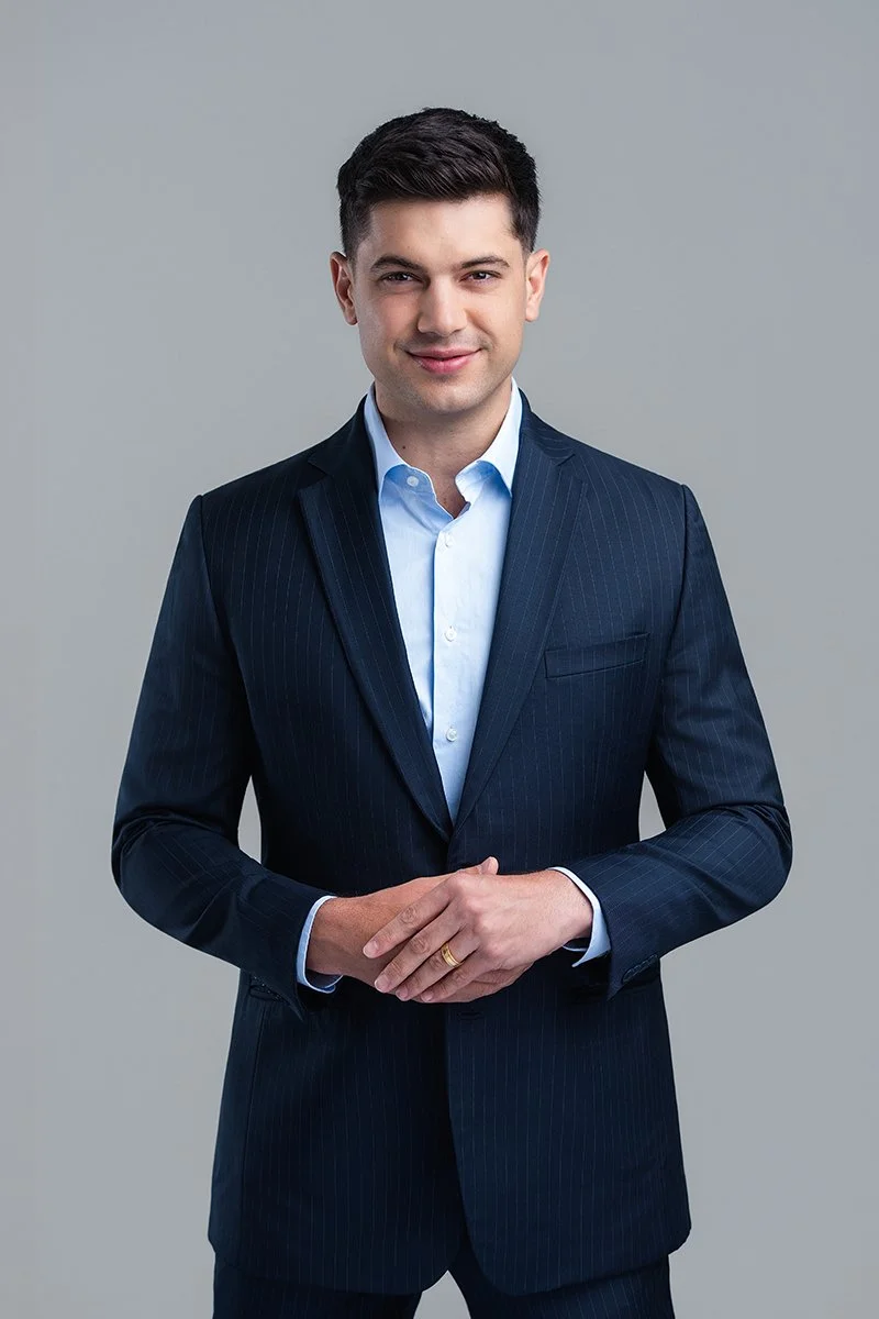 Standing half length white backdrop portrait