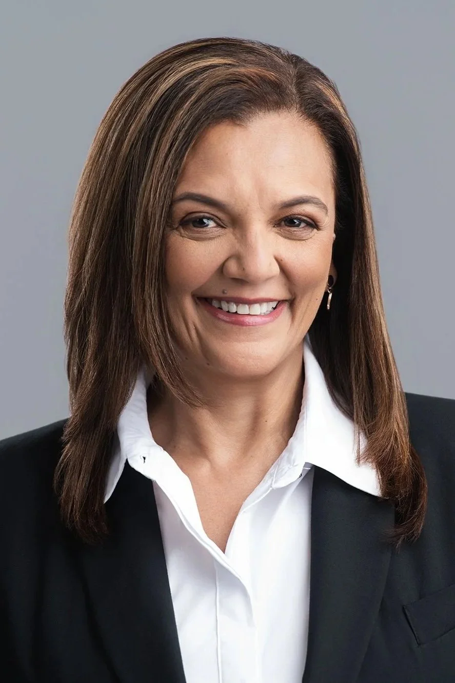 Mid waist head and shoulder headshot with light grey backdrop