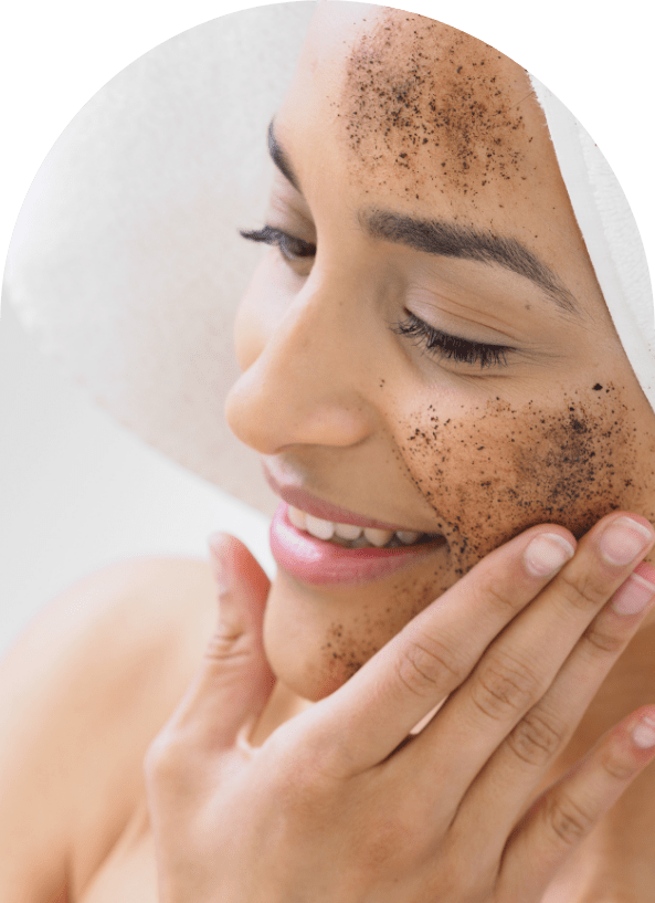 Woman using a coffee scrub on her face