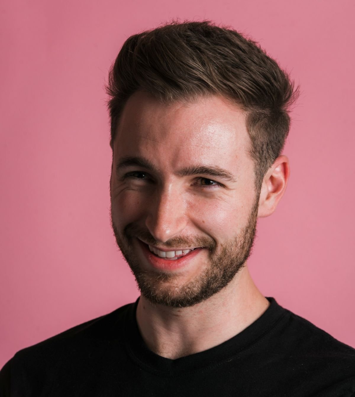Movie critic and YouTuber Griffin Schiller headshot with pink background