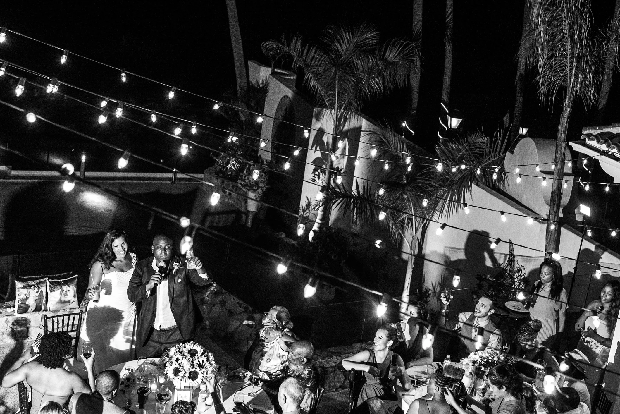 Emily and Juma toasting their guests during their wedding dinner at Casa Karma in Puerto Vallarta, Mexico.