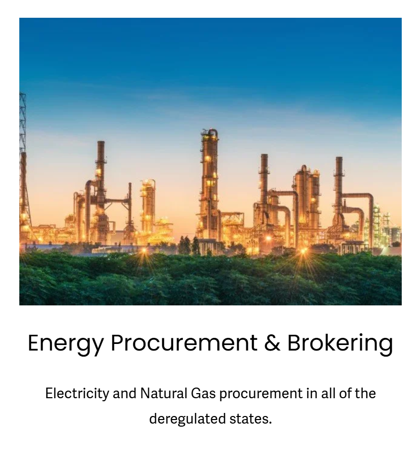 Industrial plant with multiple tall chimneys and pipes against a sunset sky, with green trees in the foreground.