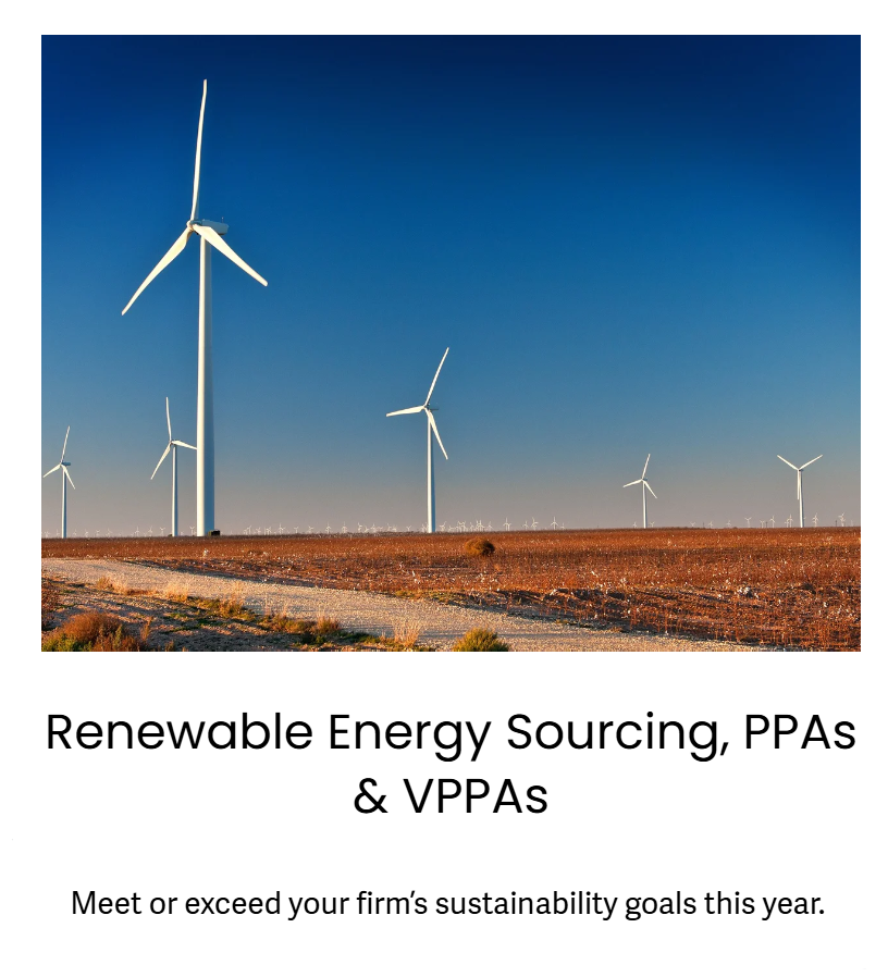 Multiple white wind turbines in a field under a clear blue sky.