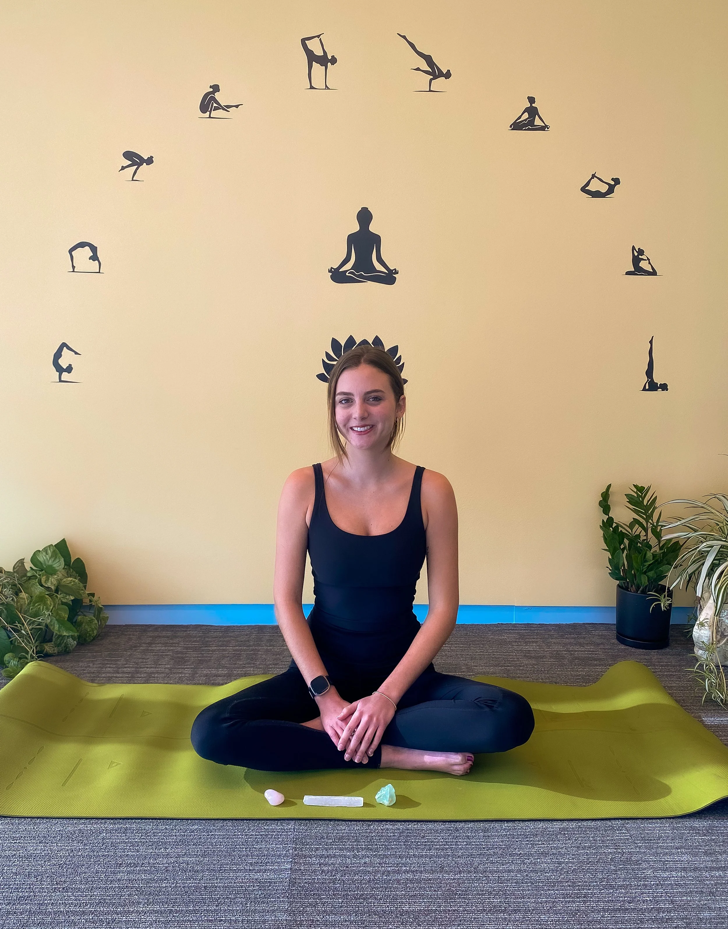 Female yoga instructor sitting in lotus pose