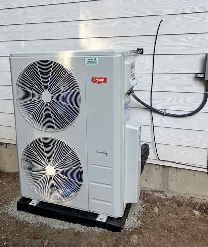A recently installed heat pump in the Eastside is shown next to house.
