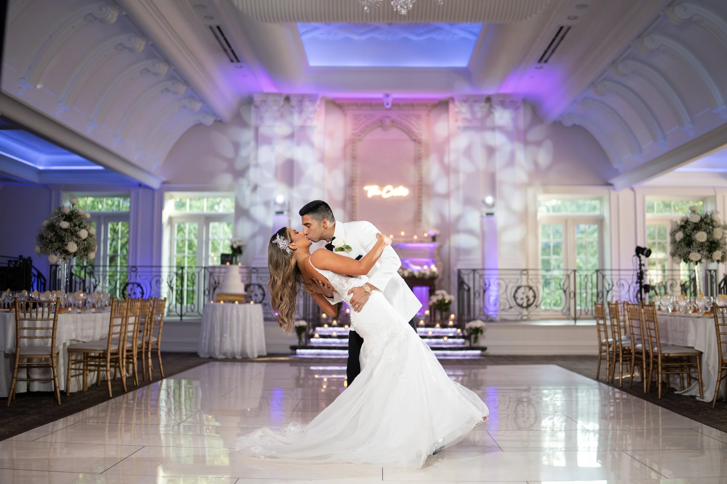 Bride and groom dip during their first dance in a New Jersey ballroom reception