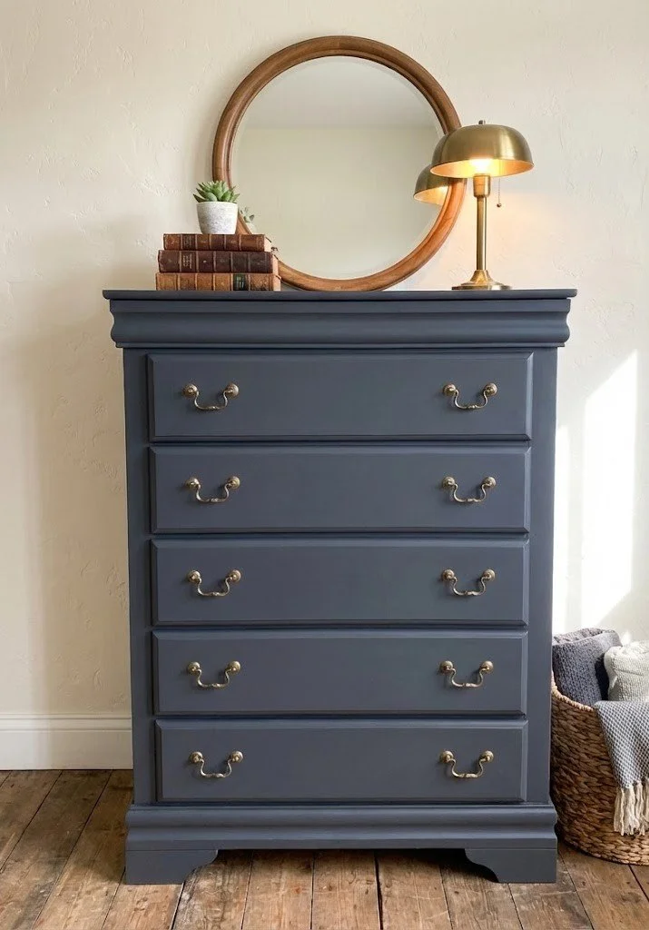 There is something so timeless about deep charcoal black paired with classic brass hardware. This 5-drawer chest has been completely refinished to bring a touch of sophisticated moodiness to any bedroom.

Sturdy, smooth-gliding drawers and a finish t