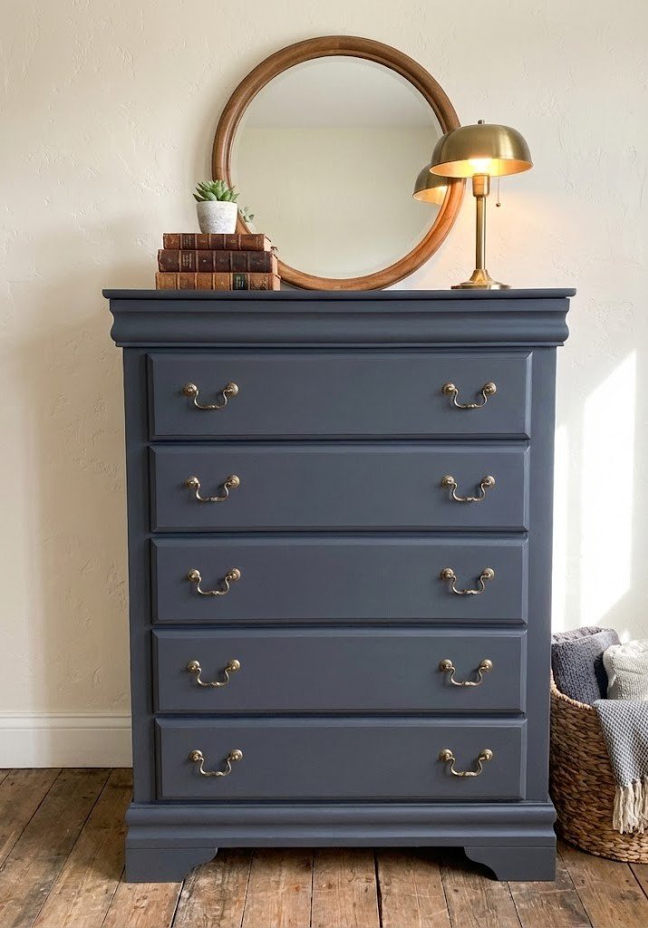 There is something so timeless about deep charcoal black paired with classic brass hardware. This 5-drawer chest has been completely refinished to bring a touch of sophisticated moodiness to any bedroom.

Sturdy, smooth-gliding drawers and a finish t