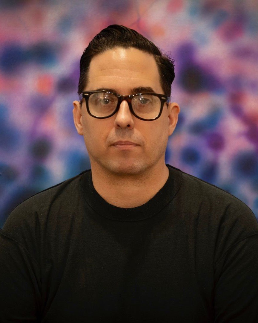 A vertical portrait of contemporary artist Erik Foss, known for his raw visual language and roots in the New York DIY scene.