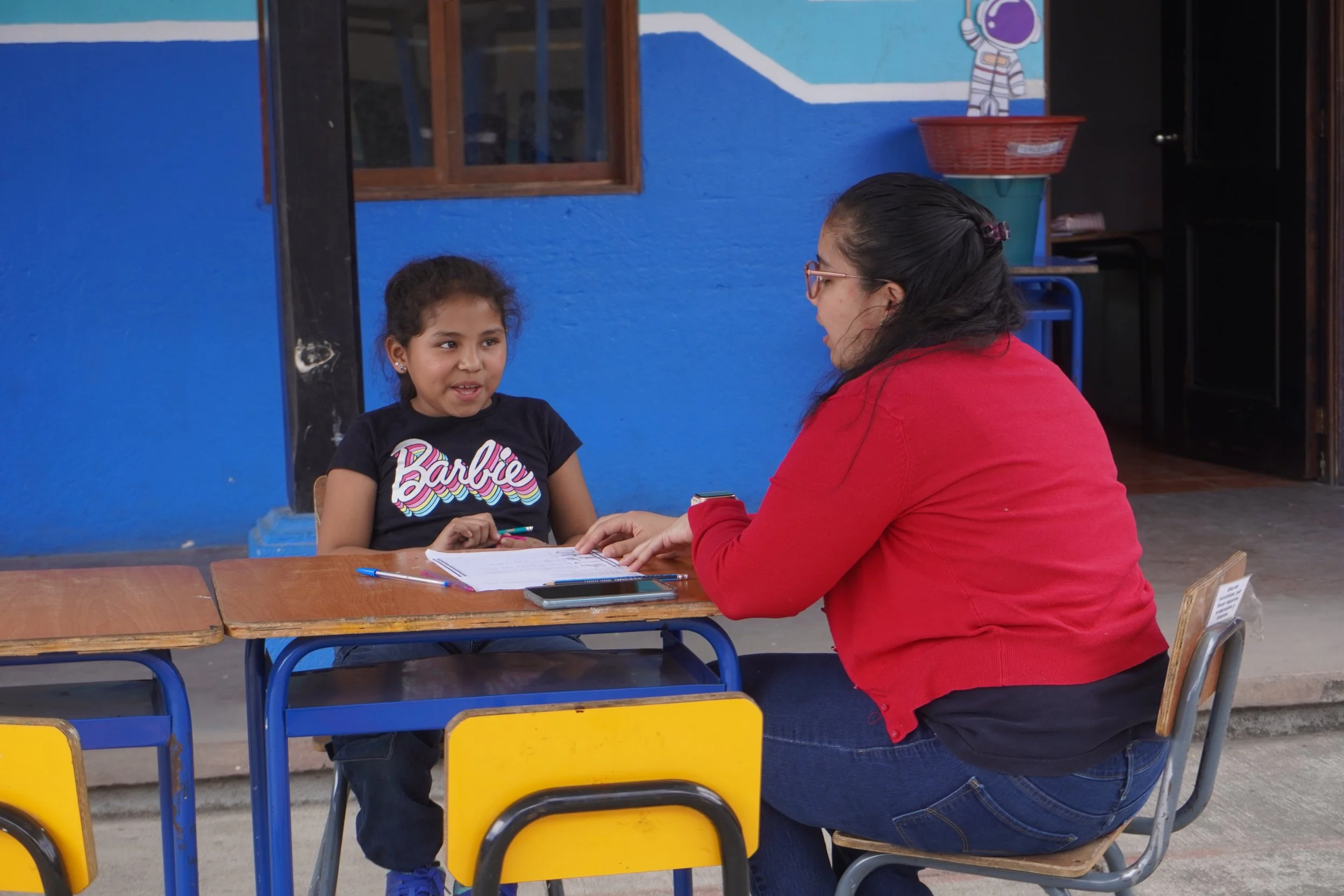 Teacher Helping Student Child At The School of Hope Guatemala