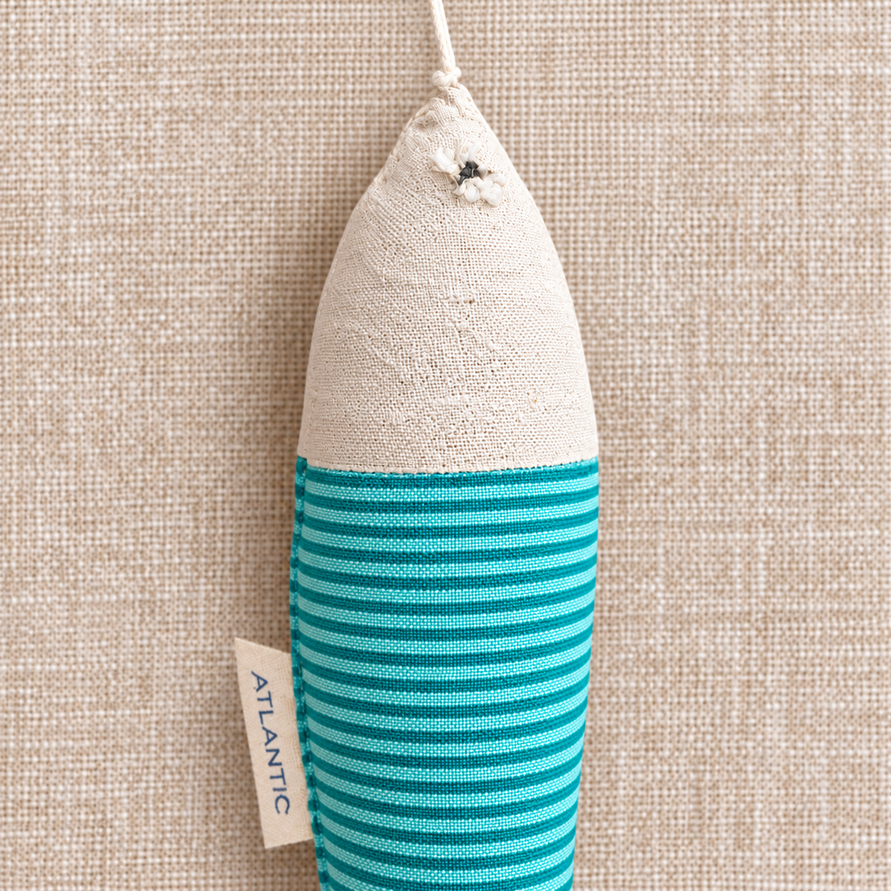 Cream fish plush on linen.png
