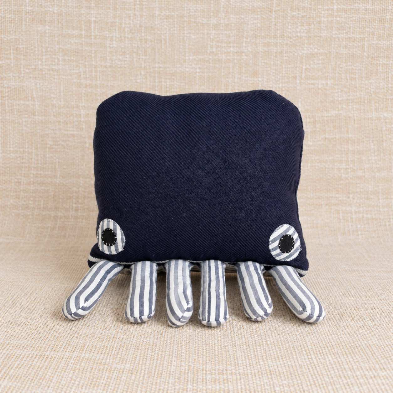 One-of-a-kind handmade navy blue cotton octopus textile sculpture with six tentacles and stitched fabric eyes, created in Yamba, Australia.