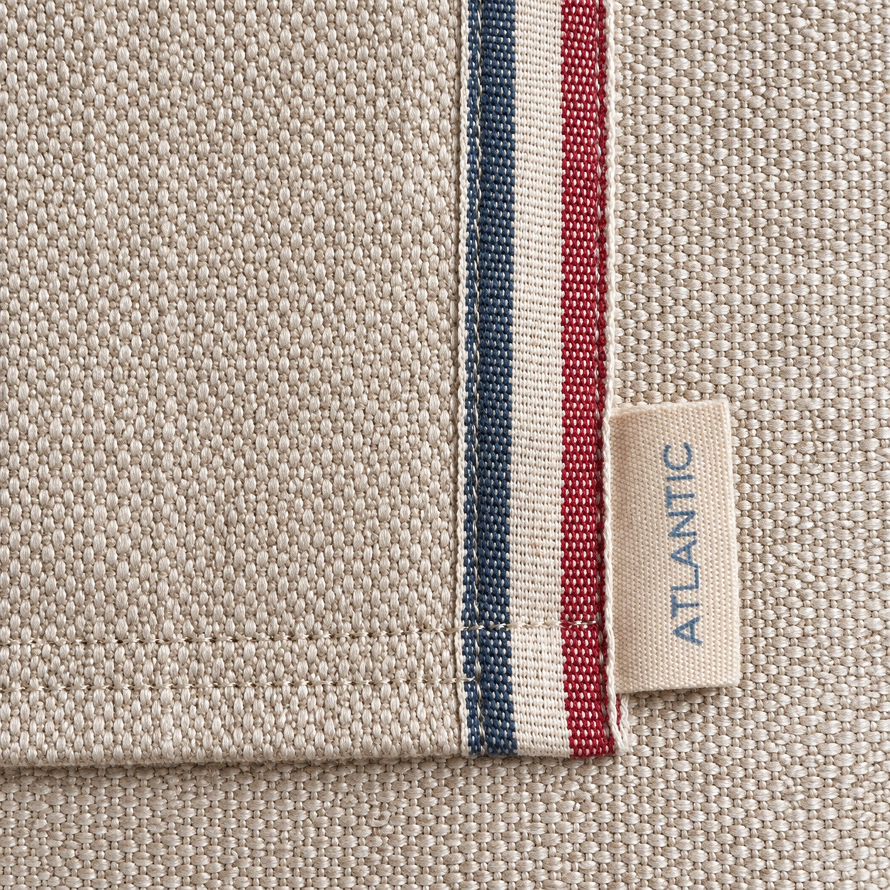 ⁠Close-up of Tidal Tote linen canvas edge with red, white and blue stripe and Atlantic Blue label