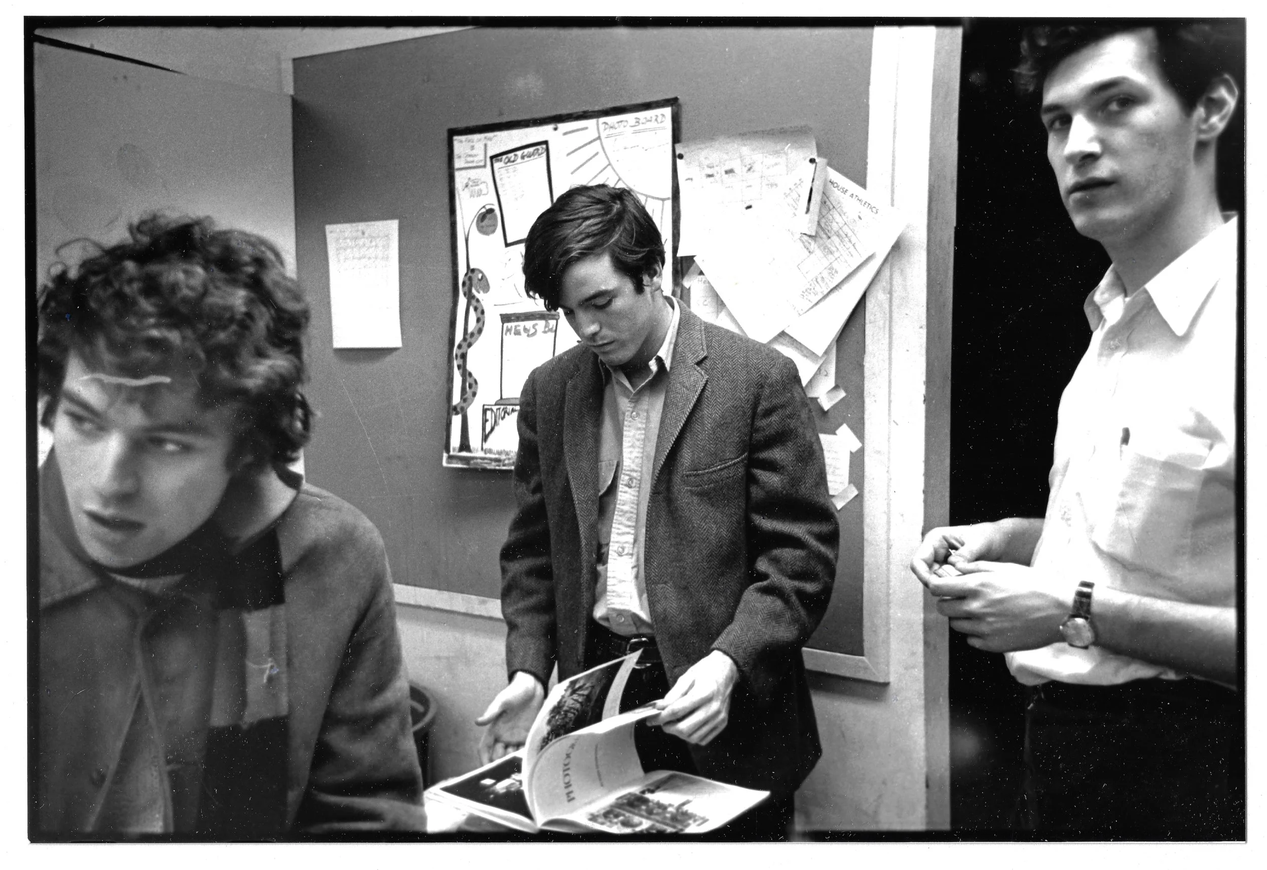 Harvard Crimson Photo Editors Victor Schrager leafing through a book and Thomas Ittelson, at right
