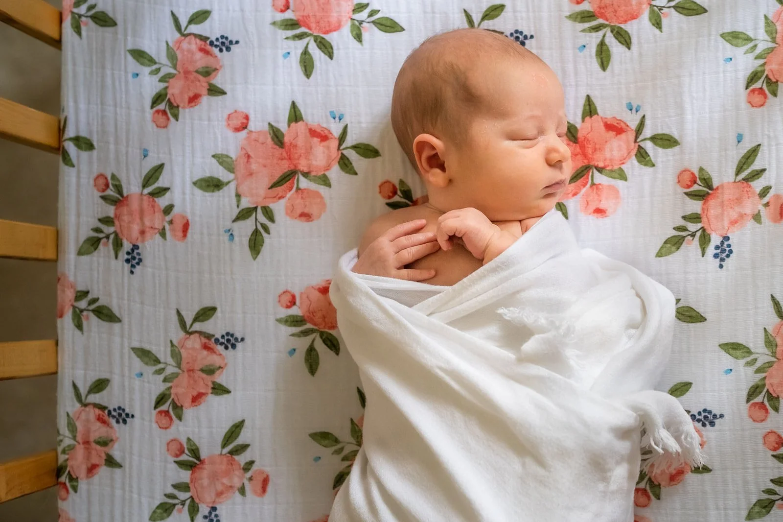 newborn-asleep-in-crib-with-roses_websize.jpg