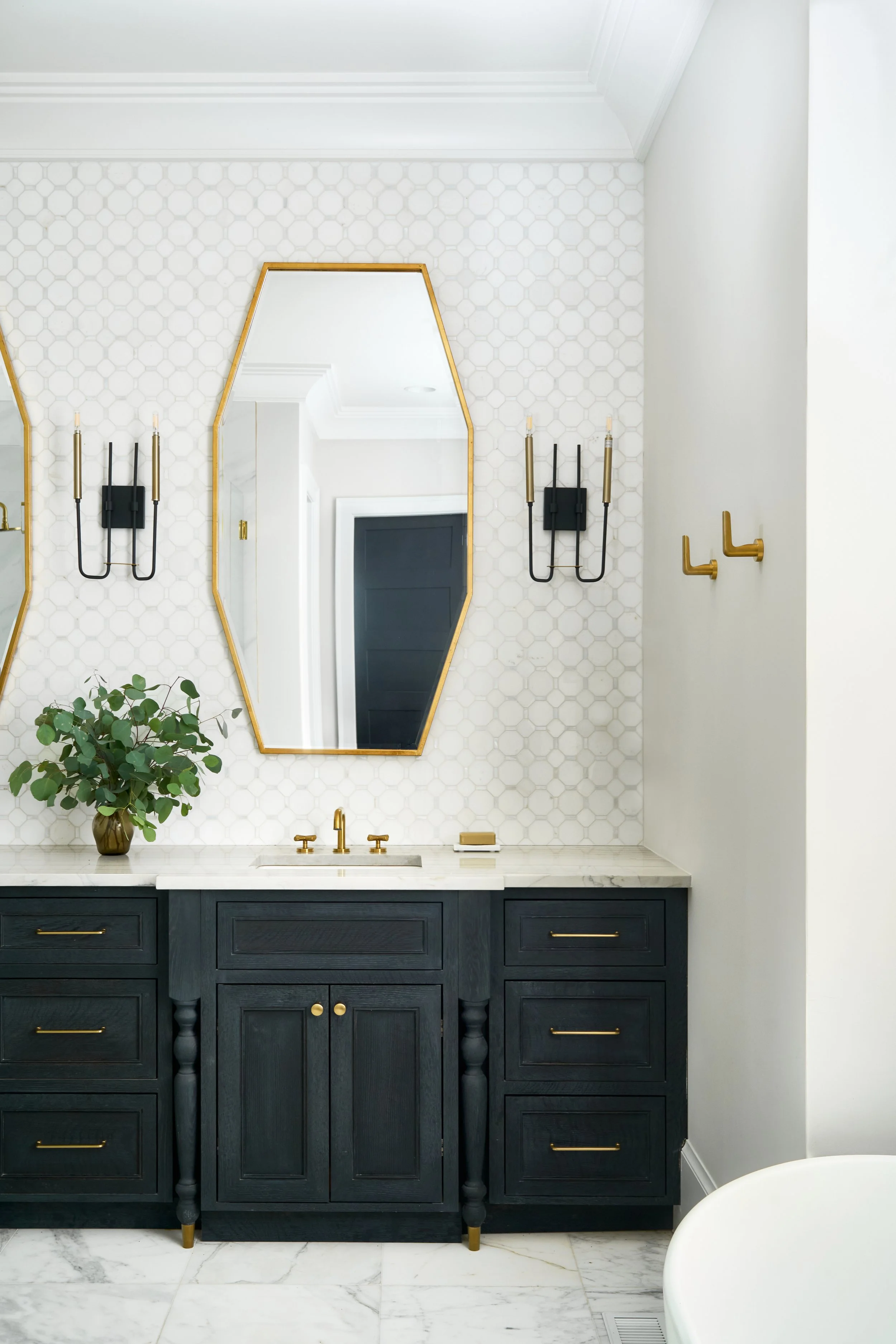 beautiful white luxury bathroom with black vanity 