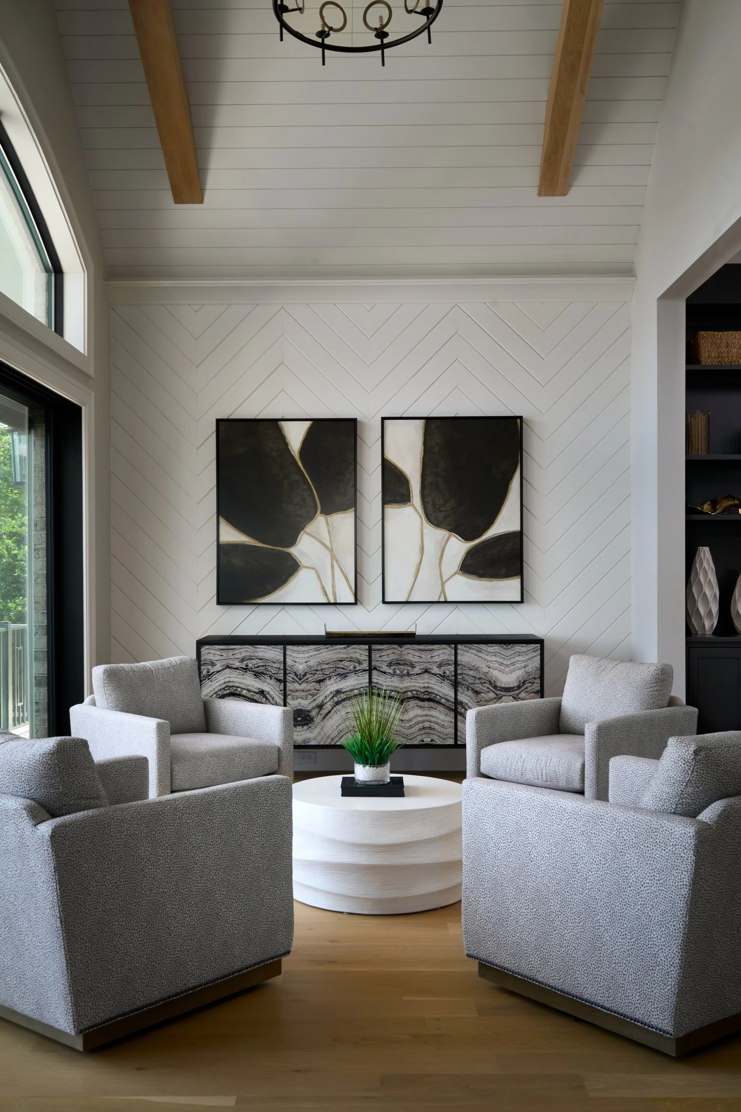 sitting room with high ceiling and large artwork 