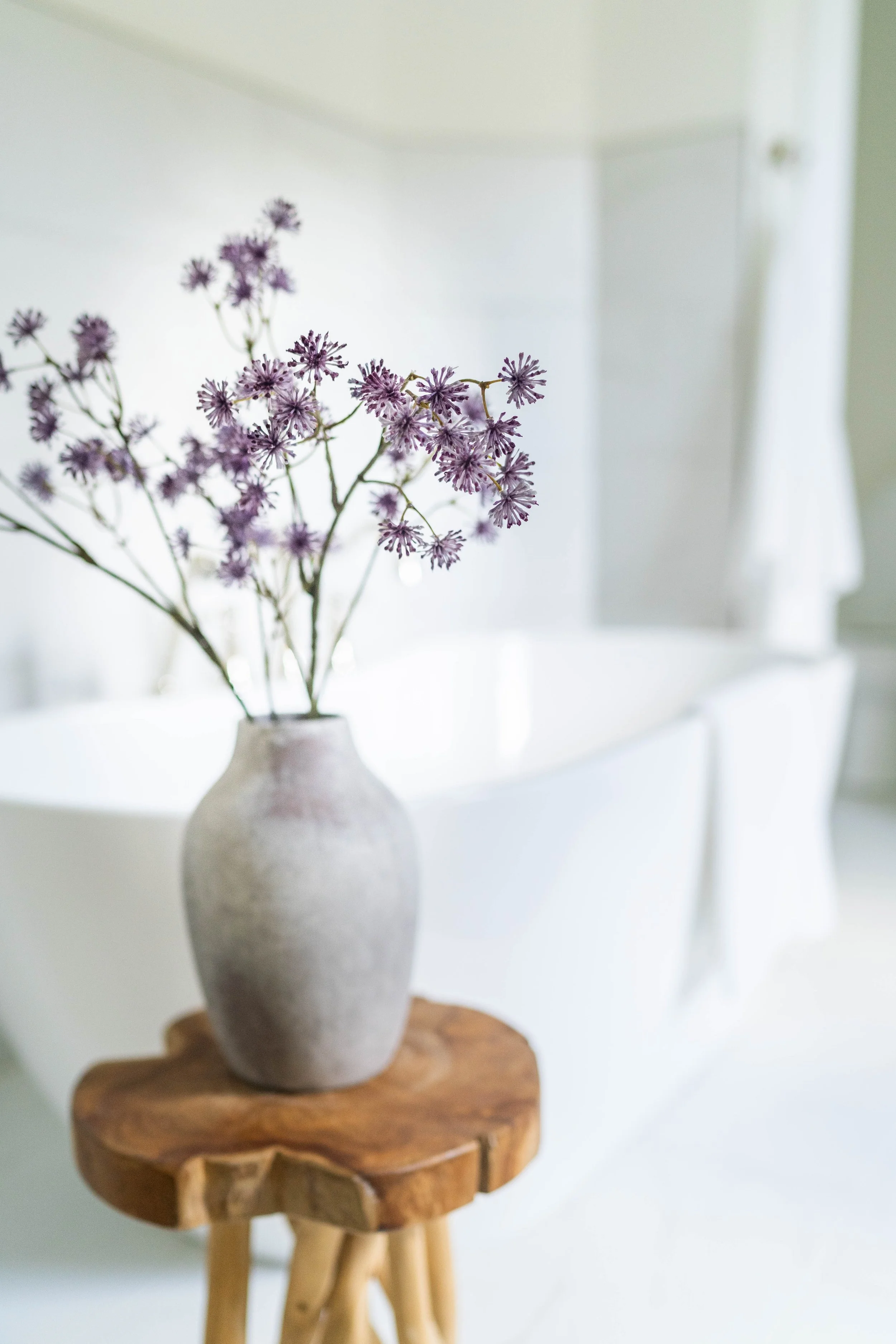 A photograph of purple flowers in a high end master bathroom located in Charlotte, NC>