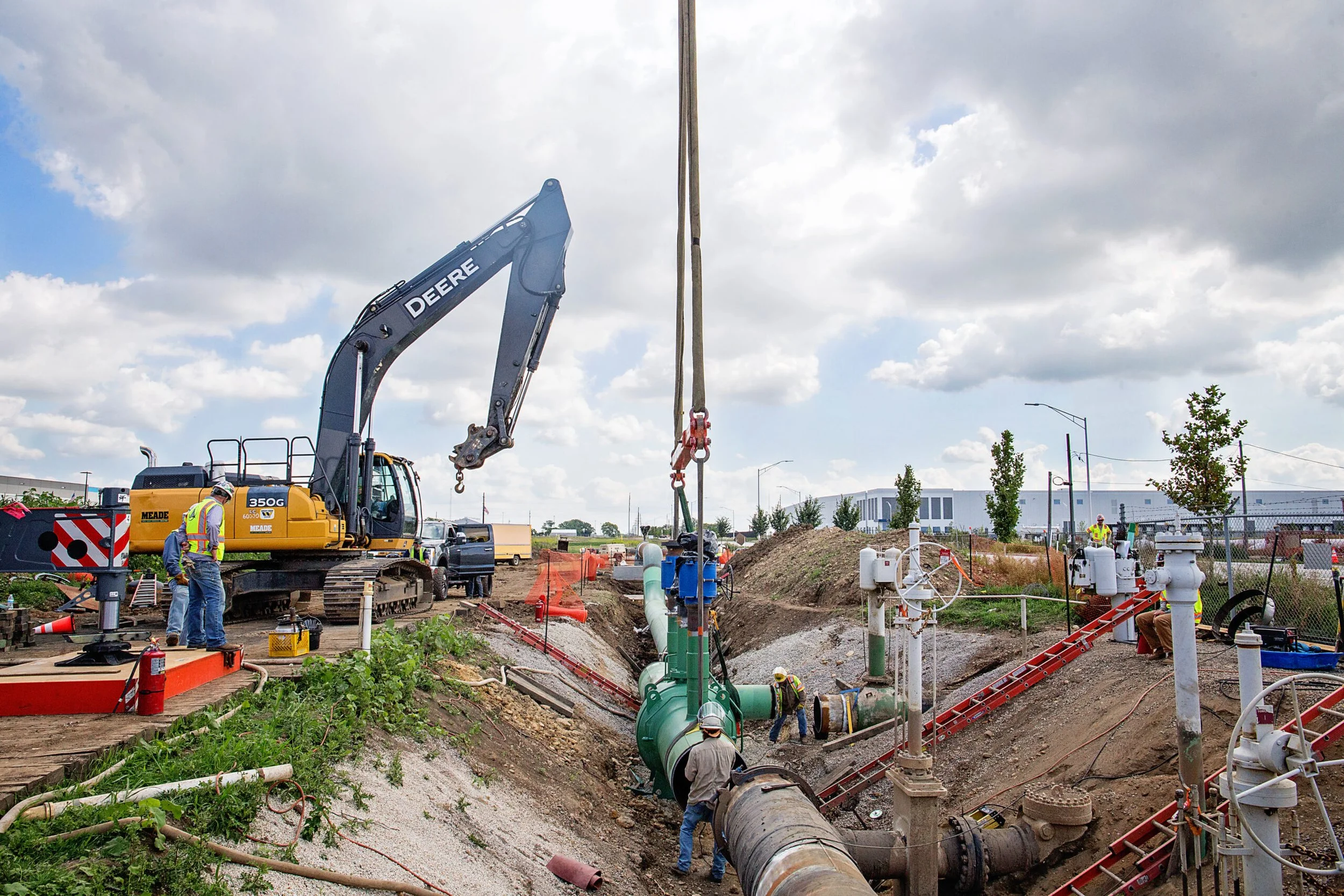 Urban construction site with a crane and a pipe, highlighting gas network pipeline inspection activities.