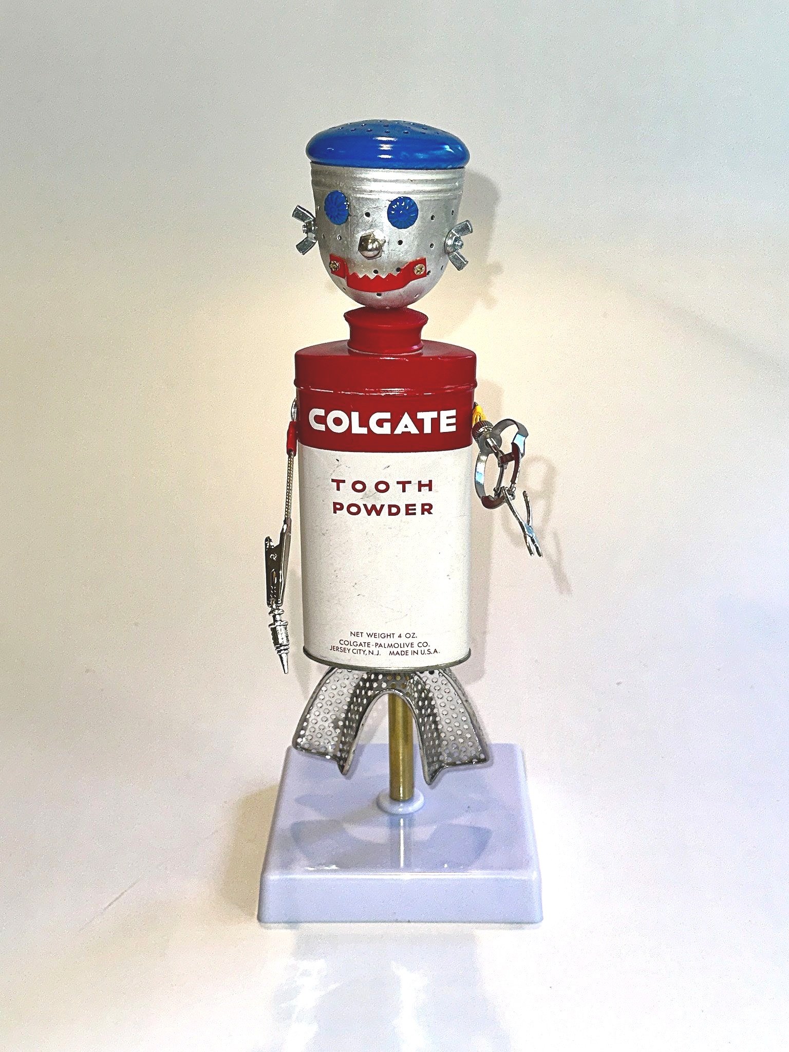Meet Dr. Phil McCavity! 12" X 4" X 7"
Vintage 1940’s Colgate Tooth Powder tin, dental impression tray, loose leaf tea infuser, Dental Matrix Bands Retainer, wingnuts, acorn nut, sawtooth hanger, furniture nails, charms.
This piece can hang directly