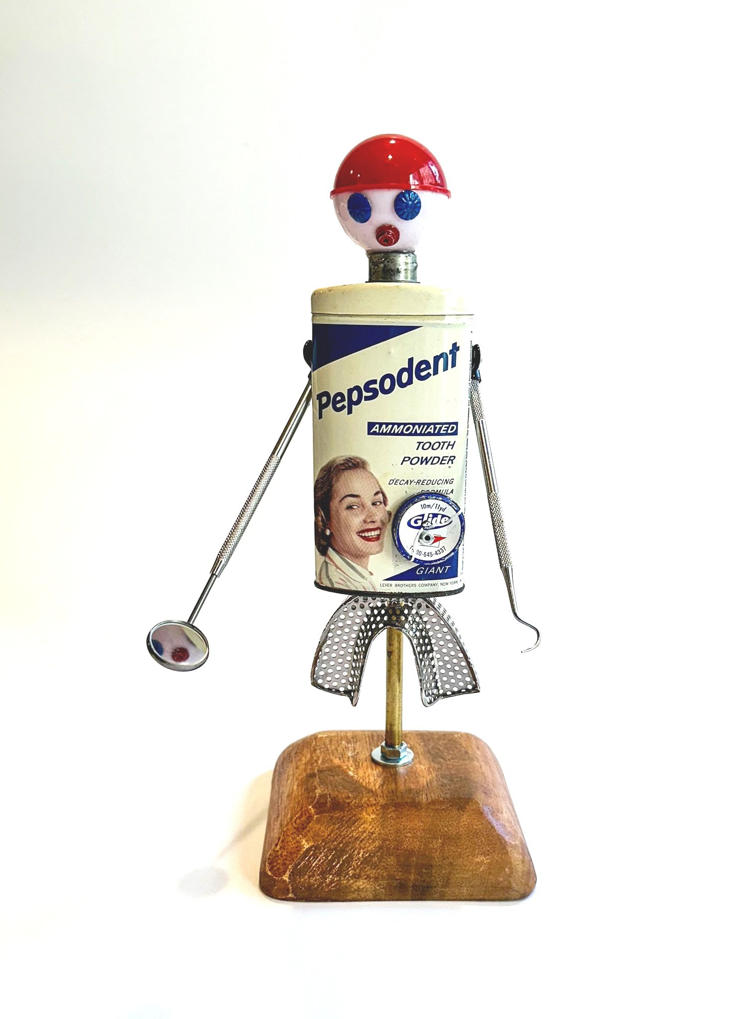 Introducing "Dr Brussian Flossmour"
12" X 6" X 6"
Vintage 1950’s Pepsodent Tooth Powder tin, dental impression tray, dental mirror, dental pic, fishing bobber, furniture nails, floss tin.
This piece can hang directly on a wall via the attached D-ri