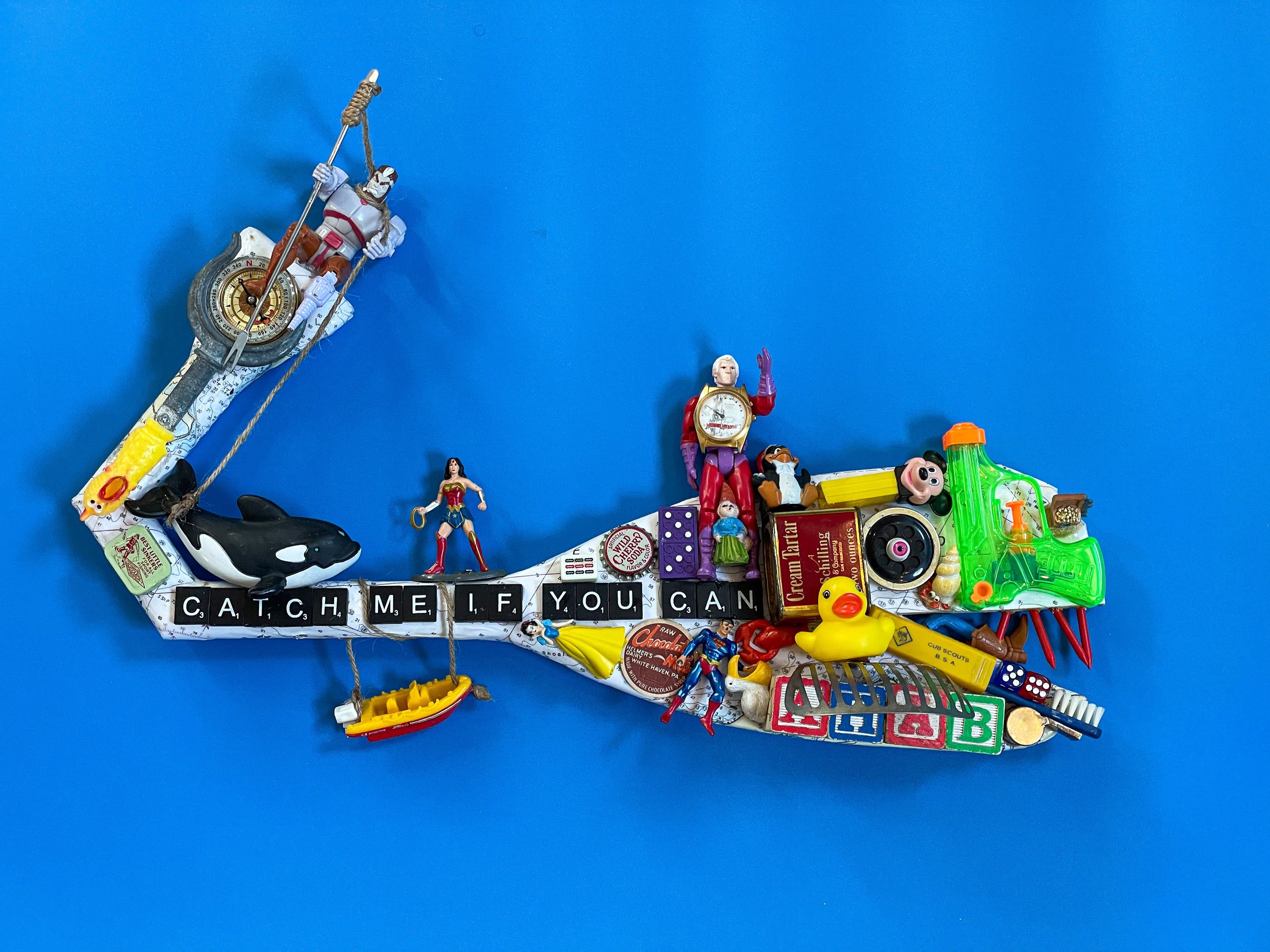 SOLD. “The MARVELous Moby Dick”
22"W X 14"H X 5"D
“The MARVELous Moby Dick” is a tongue-in-cheek modernization of the classic seafaring novel. Inspired by, and featuring, the MARVEL X-men ‘legends’ superhero Ahab, complete with peg leg, released 30
