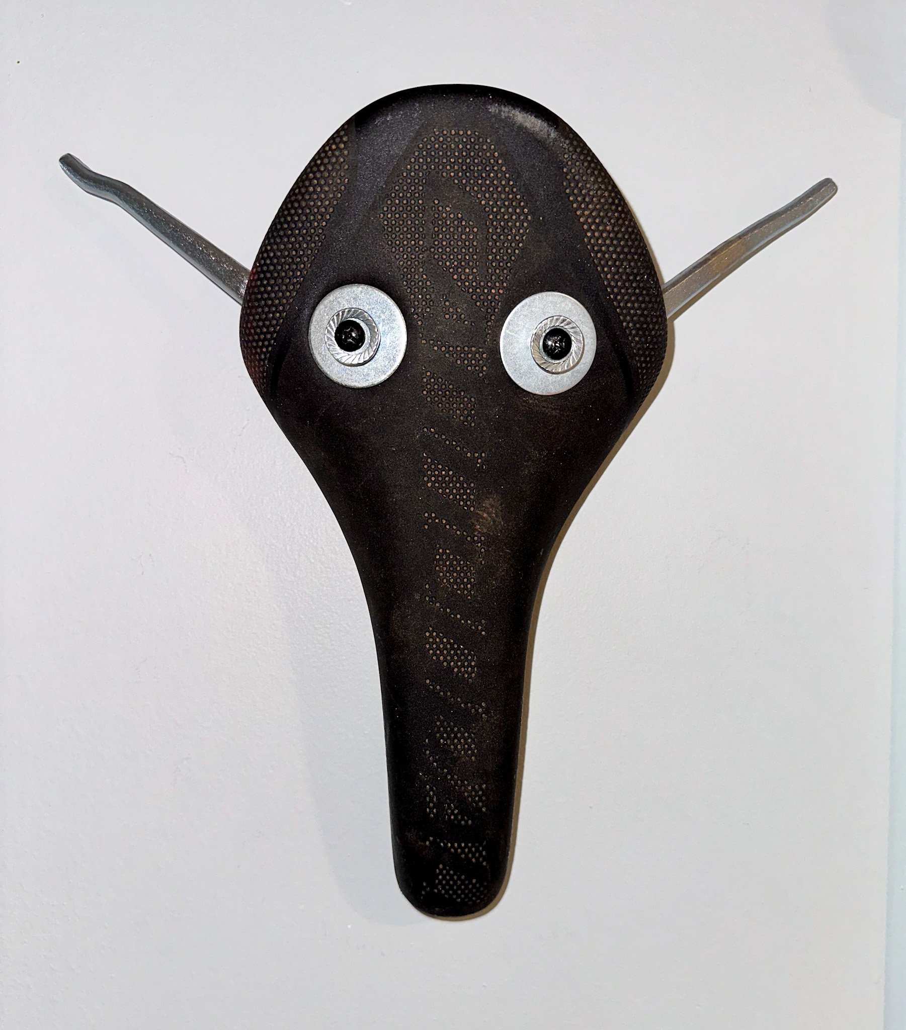 AVAILABLE. "Pablo the Bull Calf"
11" X 11" X 3"
Bicycle Seat, broken pliers, washers, nuts, screws.