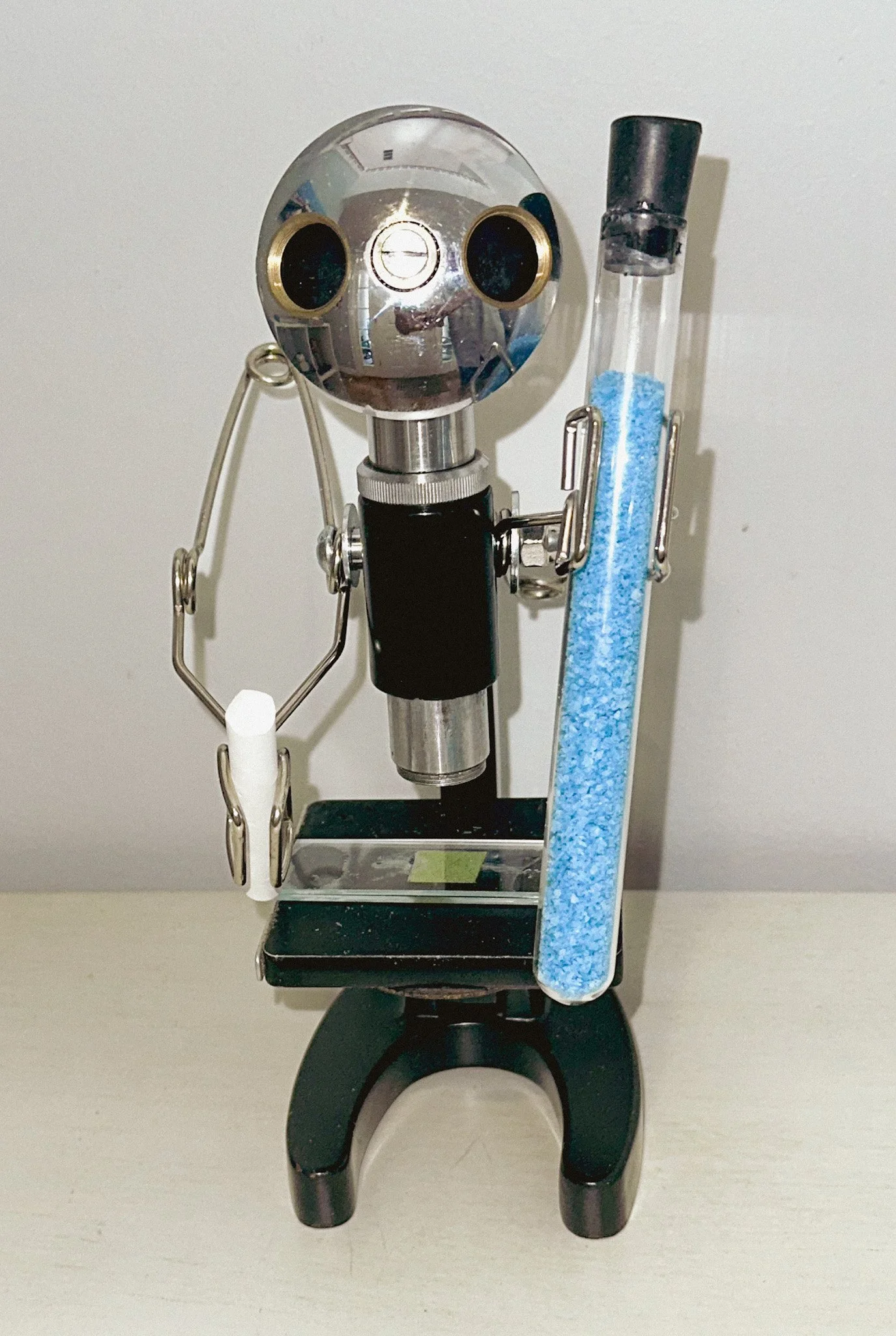 AVAILABLE. "Is the Science Teacher an Alien?" 9" X 5" X 7"
Constructed from: Antique Japanese Microscope, test tube holders, test tube, colored salt, chalk, glass slide of leaf section.