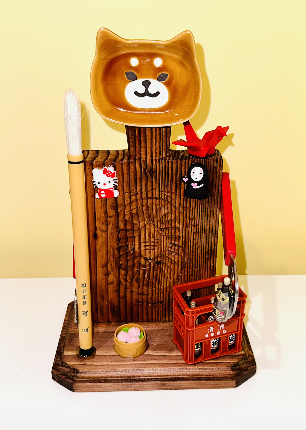 AVAILABLE. "It's a Shiba Inu World" (we just live in it).
Vintage Taiwanese cake mold, Shiba Inu chopstick rest, old Taiwanese bottle openers, toy Japanese sake crate and bottles, Japanese calligraphy brush, dumpling eraser, cable tie decorations.