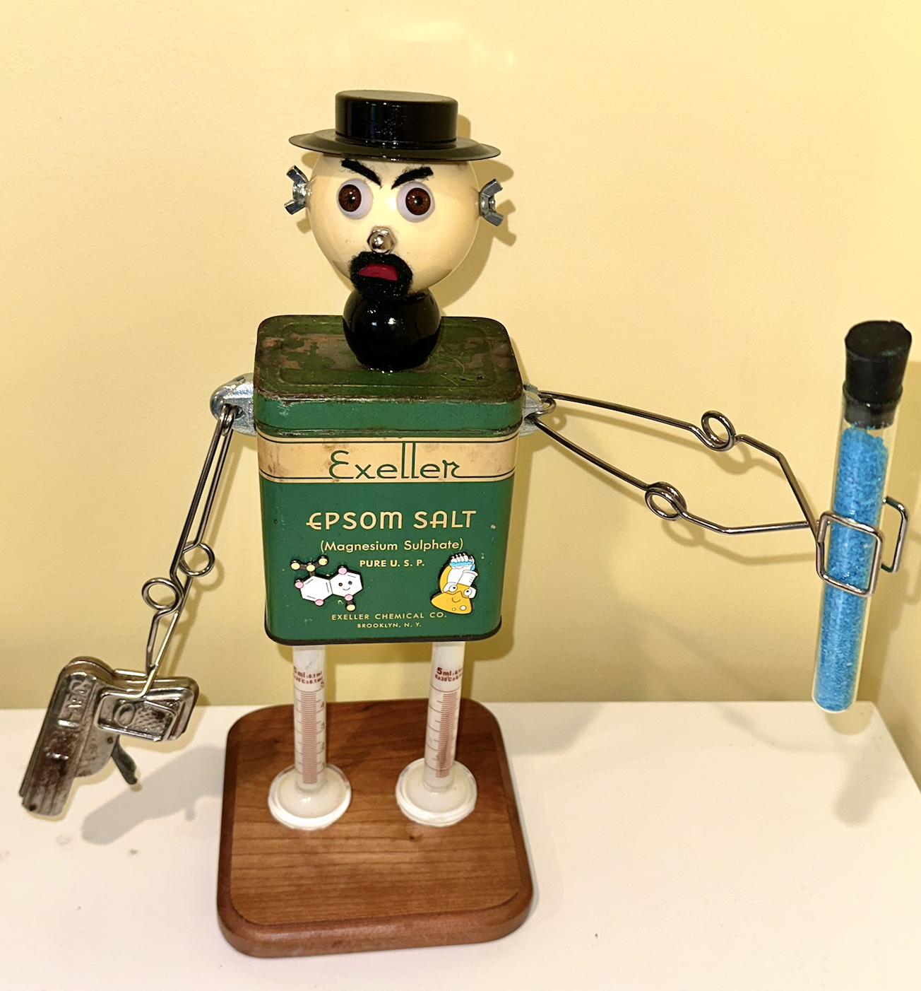 SOLD. "Walter Bradley Whyte Sr." aka "Walt" aka "Heisenberg" aka "Breaking Brad".
Vintage Magnesium Sulfate tin, old graduated cylinders, test tube holders, test tube, painted rock salt, vintage toy gun, billiard ball, doll eyes, wing nuts, half of