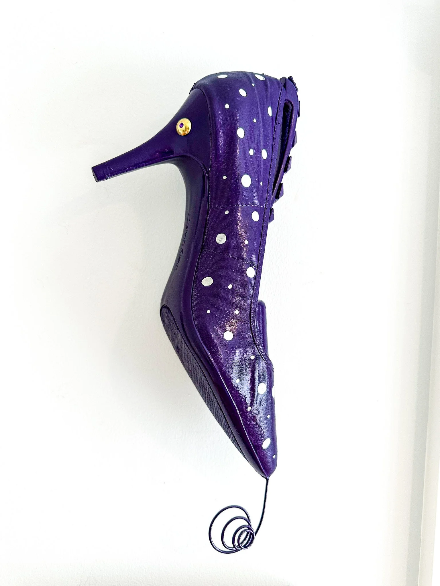 AVAILABLE; "Sophia the Spotted Seahorse Shoefish" 12 X 3 X 7.
Constructed from a Calvin Klein black cloth high heel shoe, wood and plastic shoe tree, flashlight battery compartment spring, furniture nails.