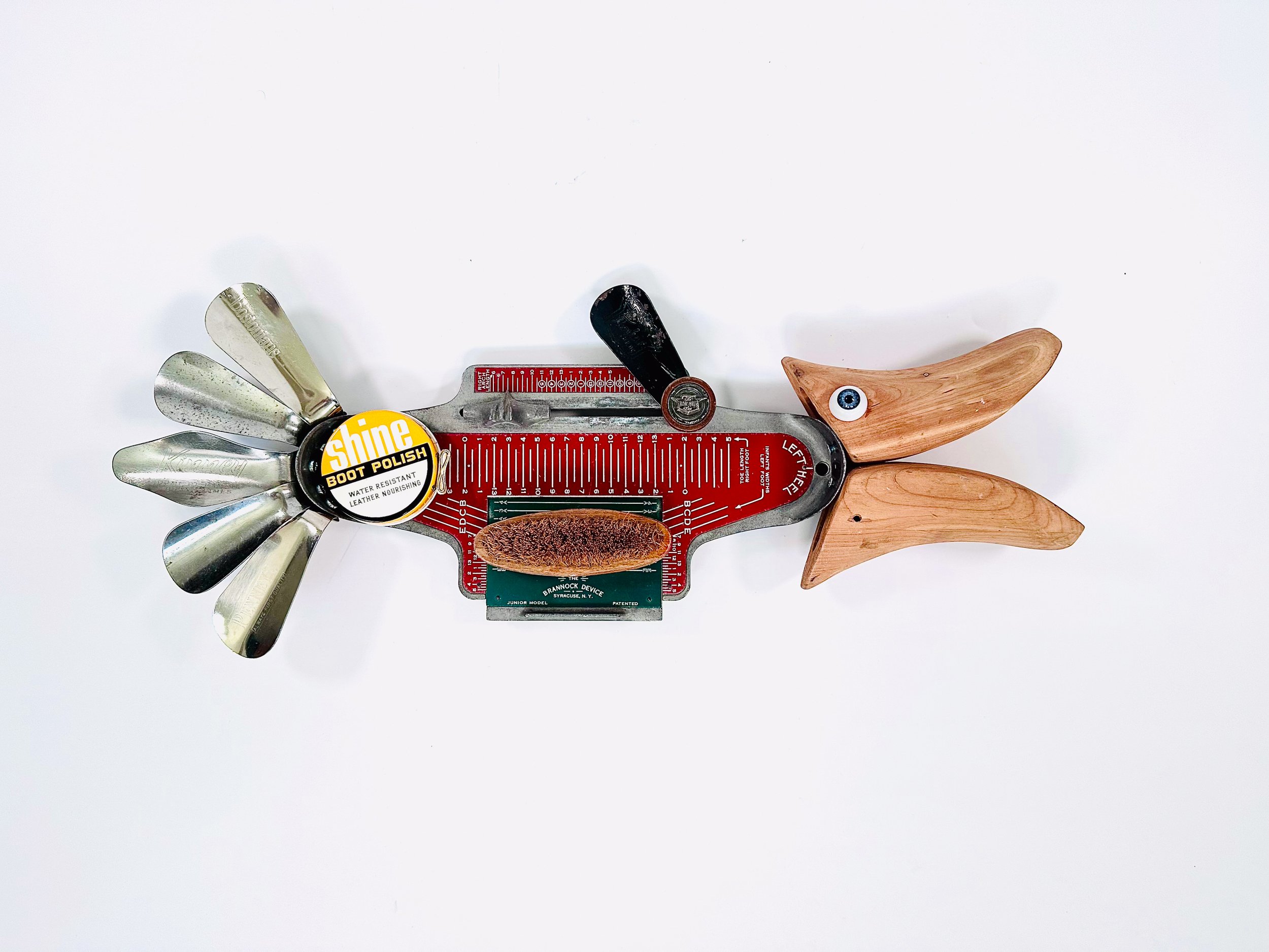 SOLD: Shoefish; 23" X 9" X 2.5"
Brannock foot measurement device, parts of shoe trees, shoehorns, shoe polish tin, doll eye.