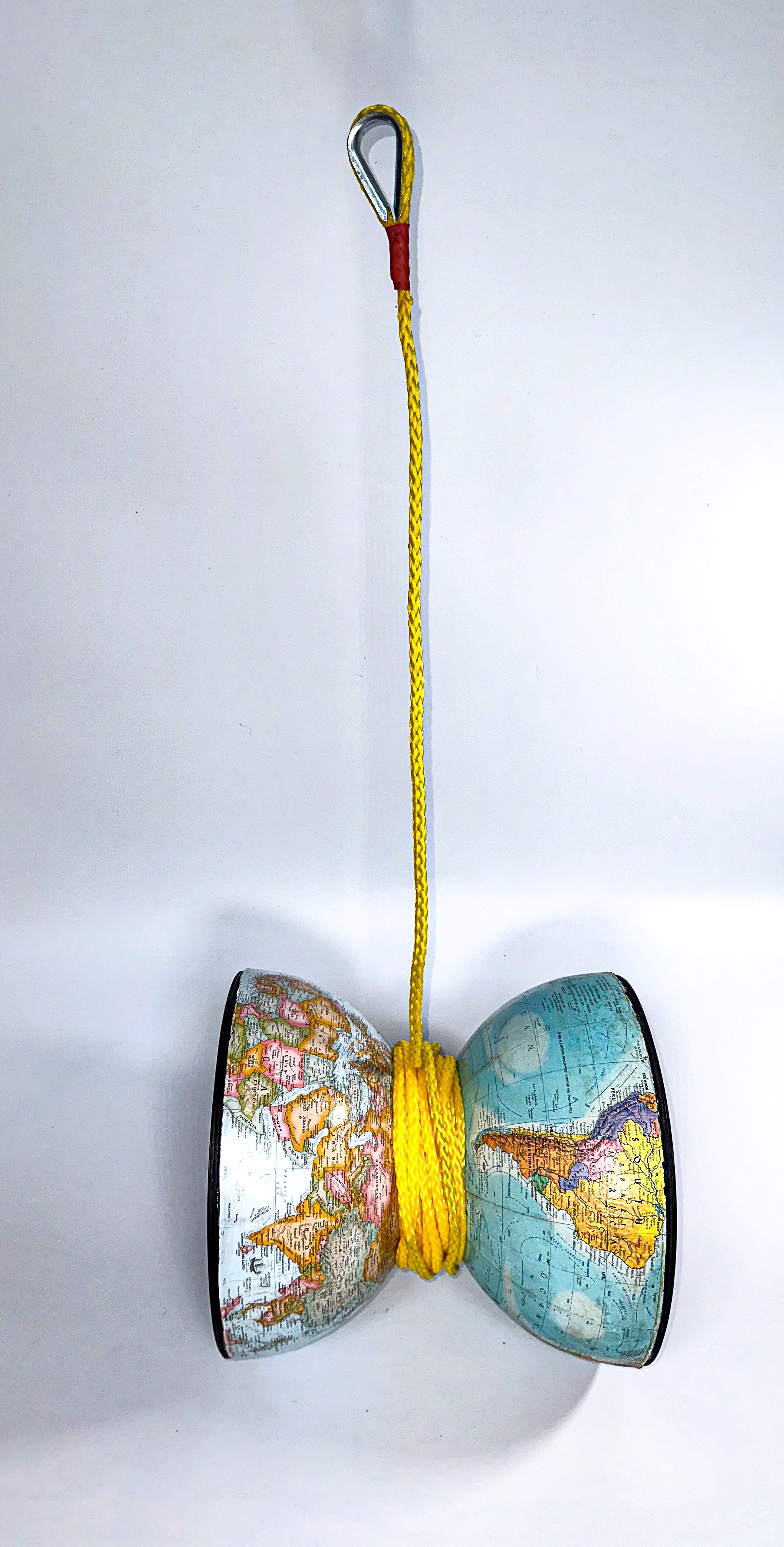 SOLD; Never before exhibited!
"Life's full of ups and downs when you live on a Cosmic Yo-Yo!"
38 X 14 X 12
Halves of two different globes, 2 LP/33 1/3 records. wooden discs, hollow-core braid rope, hardware.