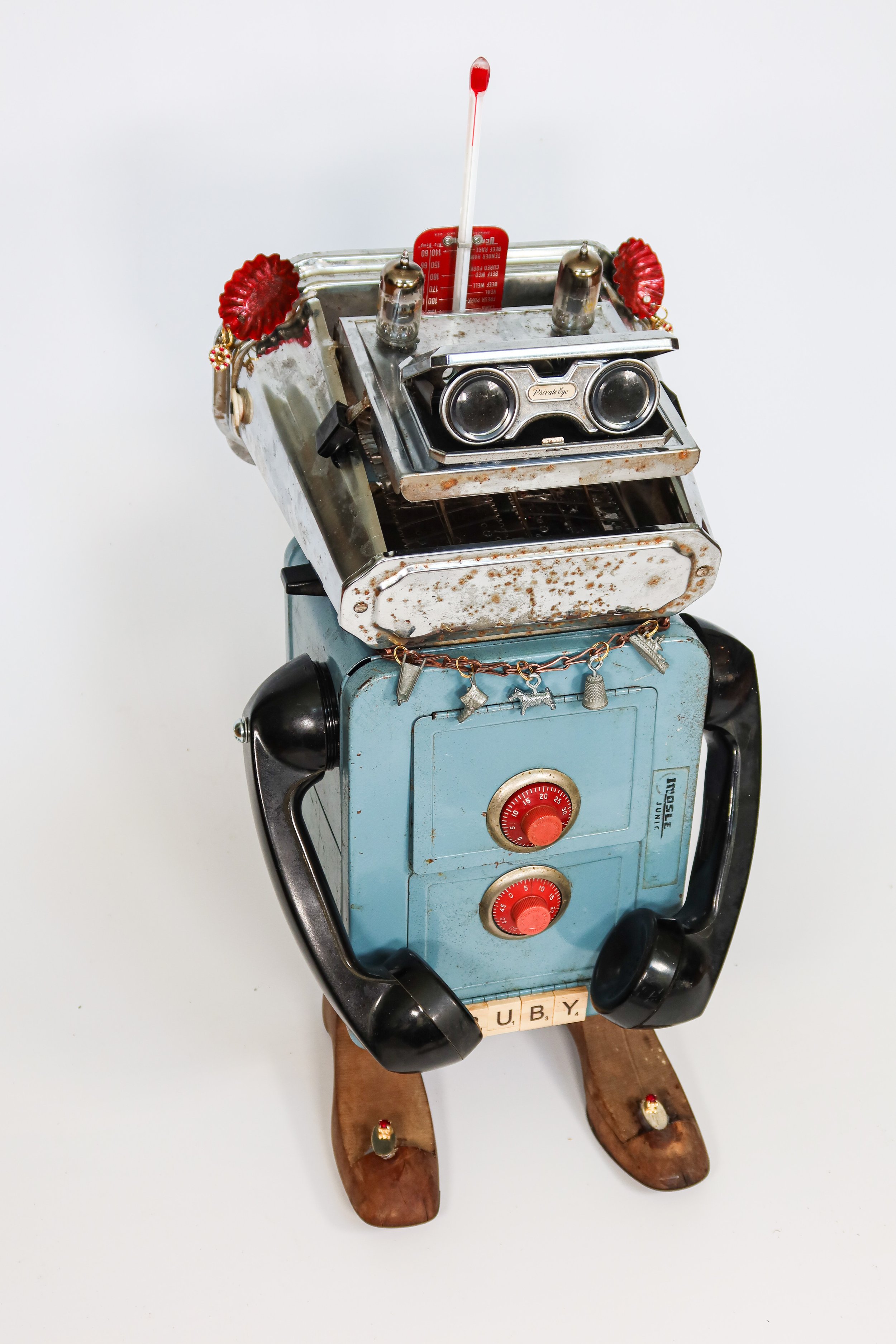 SOLD. Found Robot #2; Ruby.
Safe, phone handsets, shoe forms, scrabble tiles, vintage cufflinks, monopoly pieces, sash chain, vintage toaster, opera glasses, vacuum tubes, meat thermometer, candy molds, earrings.
26"T X 12"W X 14"D.