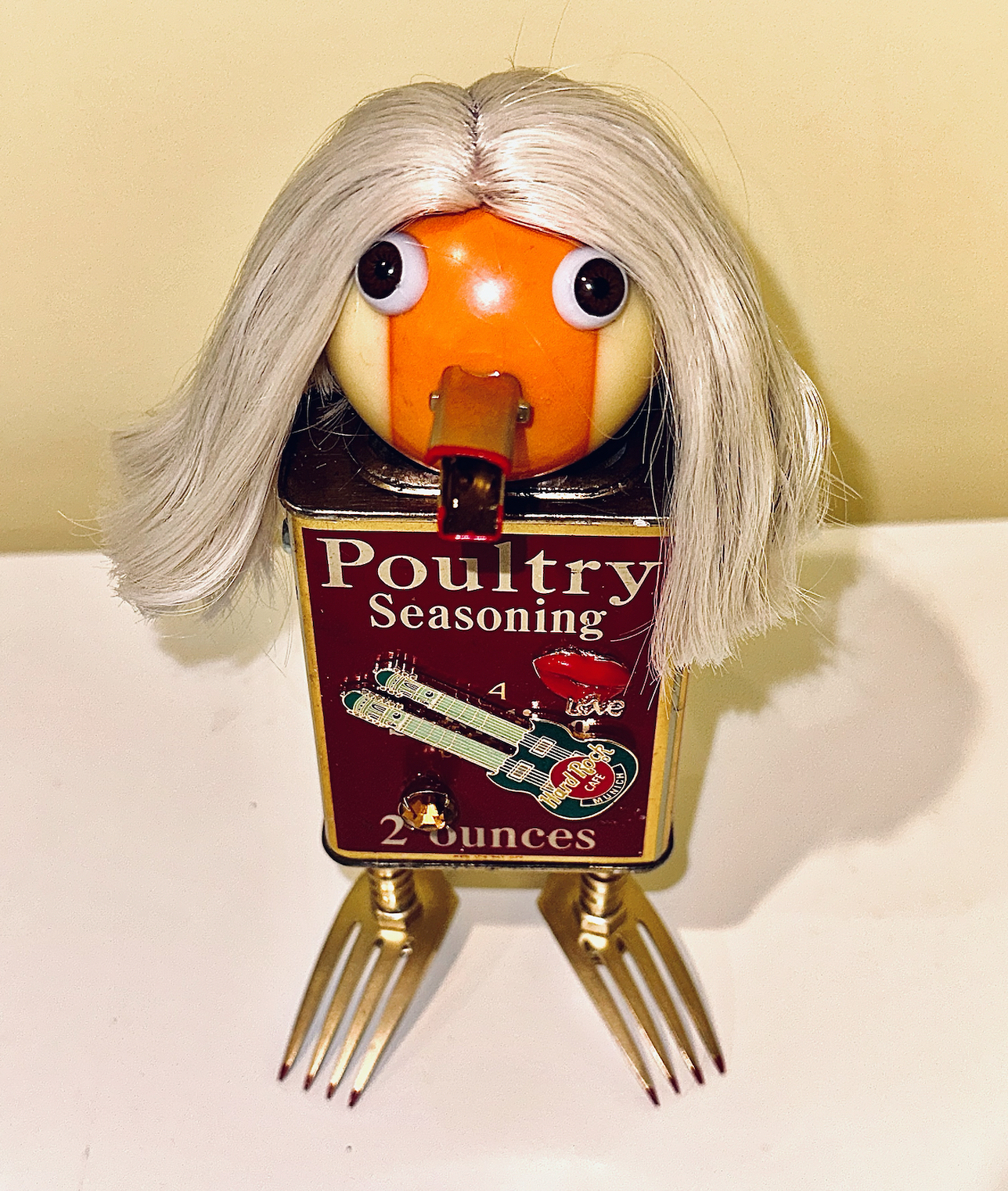 SOLD. “Chickira” To be exhibited at the Featherstone Gallery of the Arts Holiday Gift Show, Nov 13 - Dec 17.
9" X 5" X 4"
Vintage spice tin, billiard ball, forks, hose connectors, toggle anchor, doll eyes, doll hair, apple corer, steamer leaves, cos
