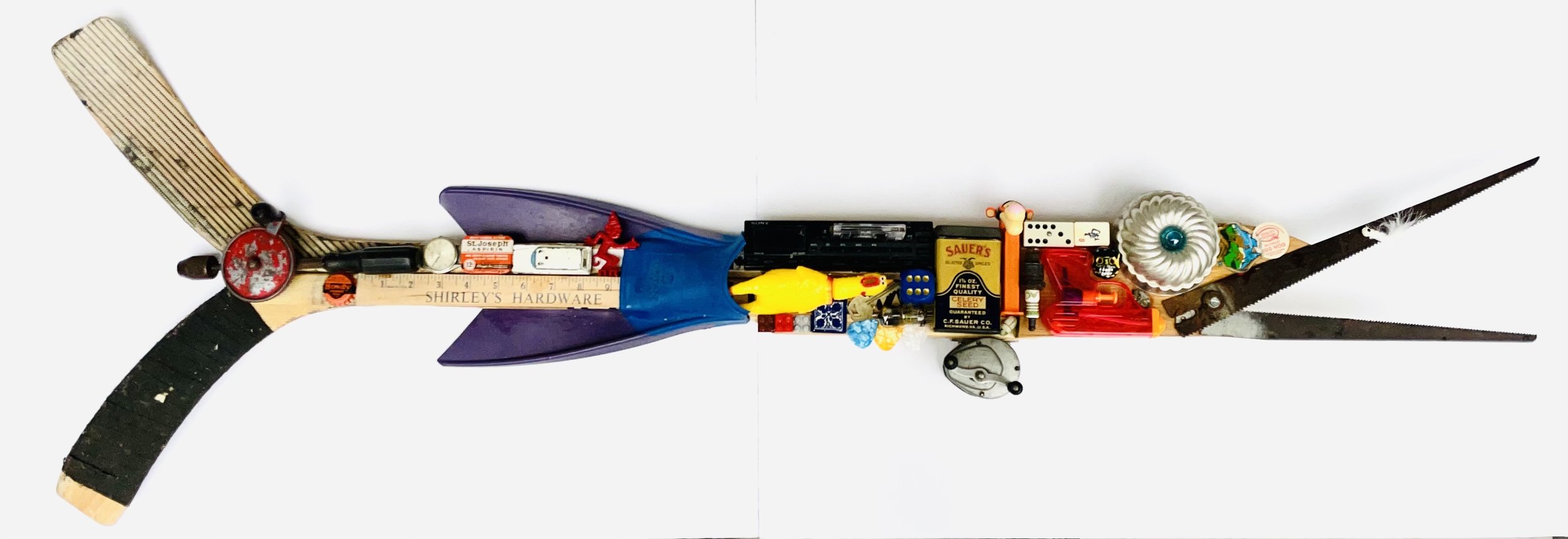 SOLD. Found Fish #8; hockey sticks, swim fin, old saw blades, kitchen utensils, toys, vintage fishing reel.
52"W X 16"T X 3"D.
