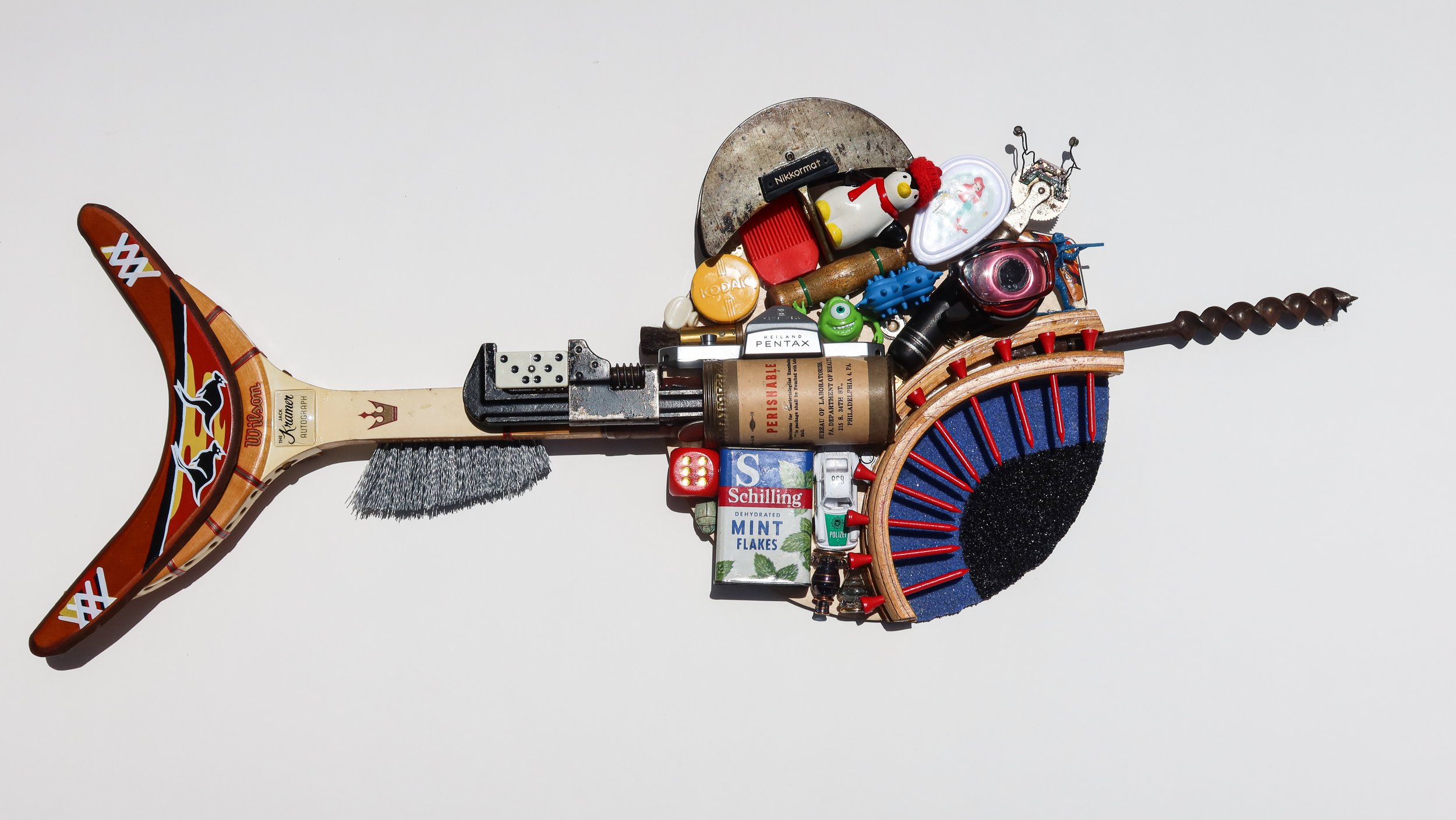 SOLD. Found Fish #2; vintage tennis racquet, toy boomerang, antique tools, kitchen implements, toys, camera parts.
32"W X 16"T X 3"D.