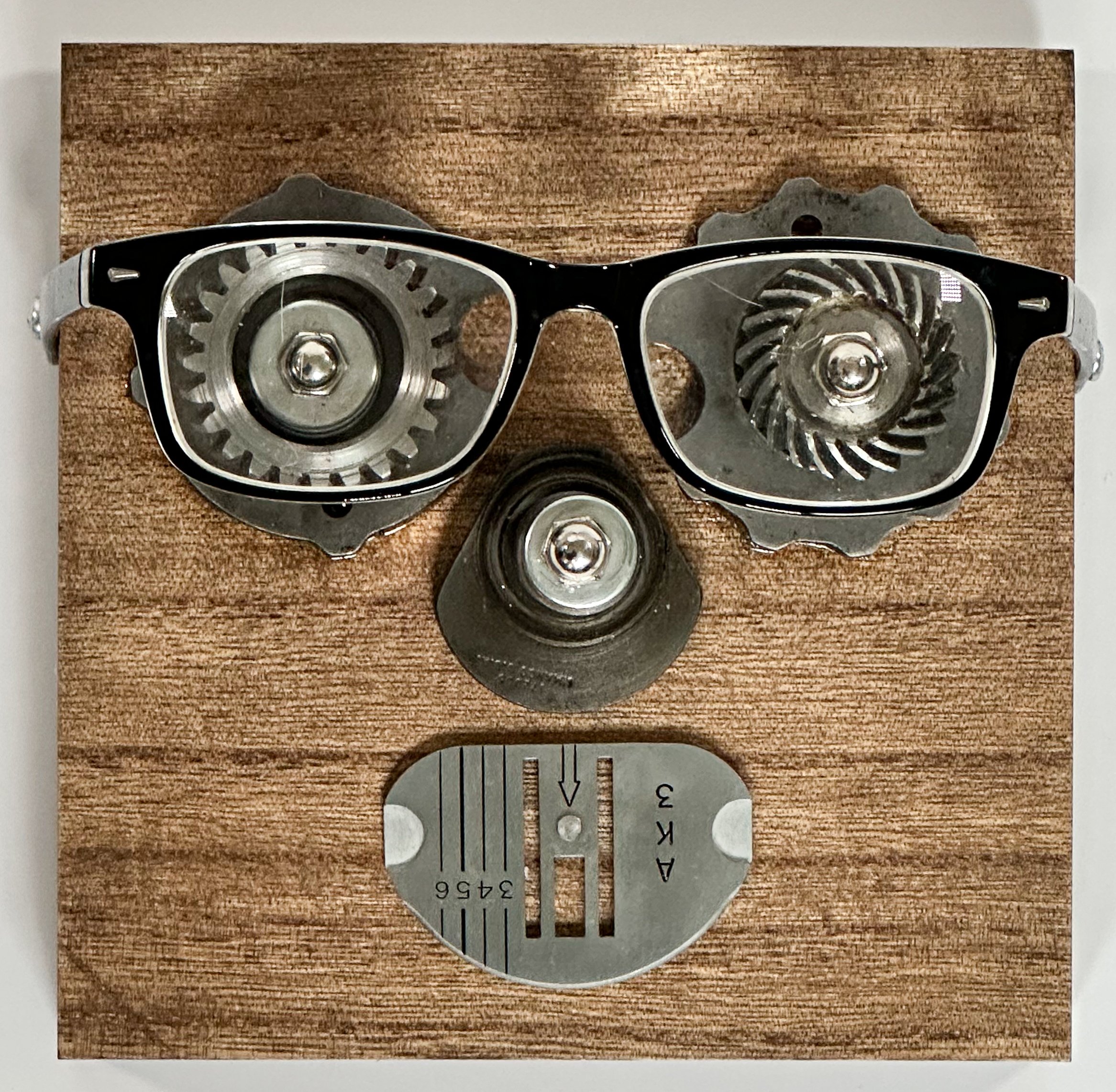 SOLD. Self-Portrait #1. All parts except wood and eyeglasses are from a 1957 Singer sewing machine.